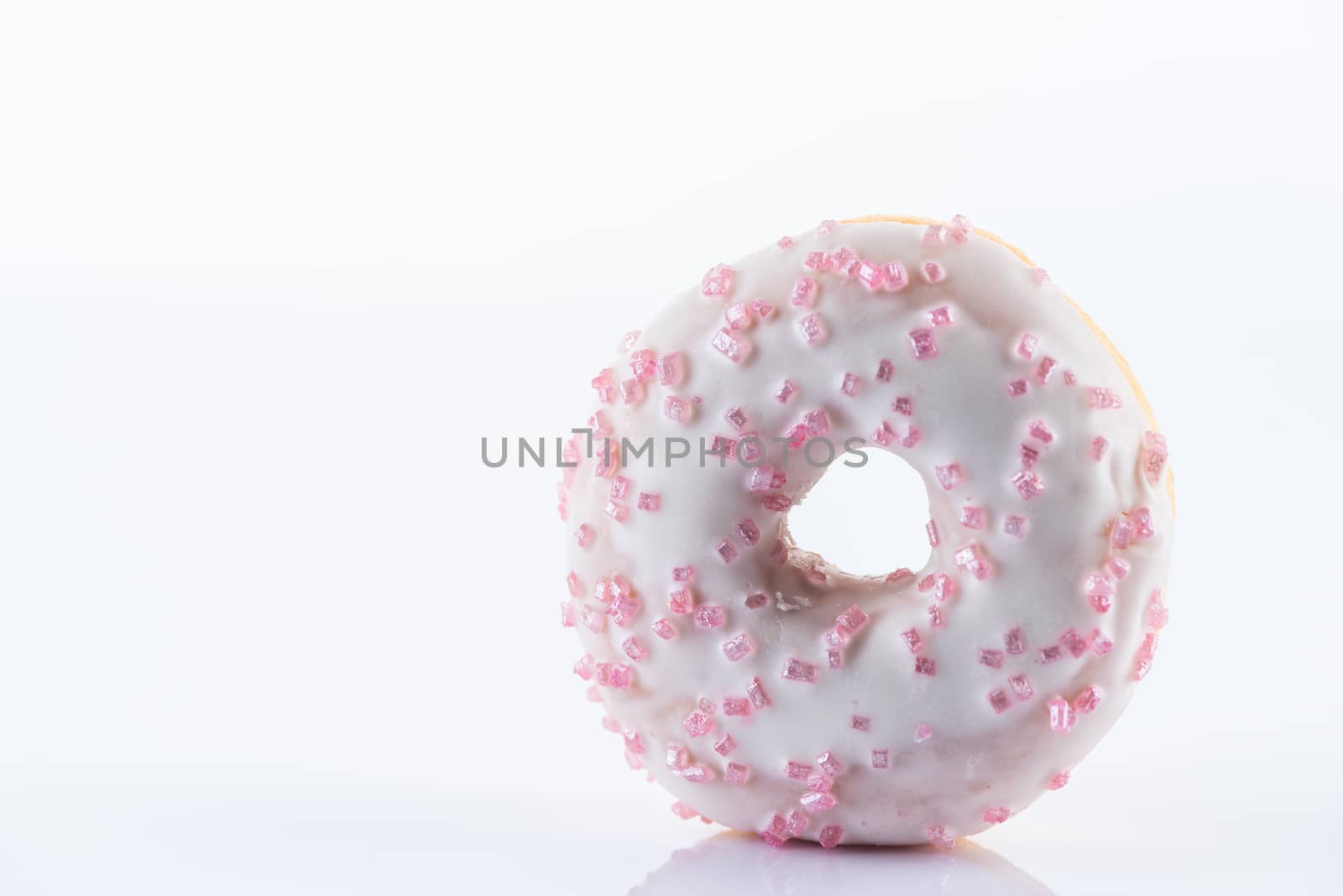 Single White Chocolate Donut or Doughnut. Studio Photo on White Background, Close Up view.