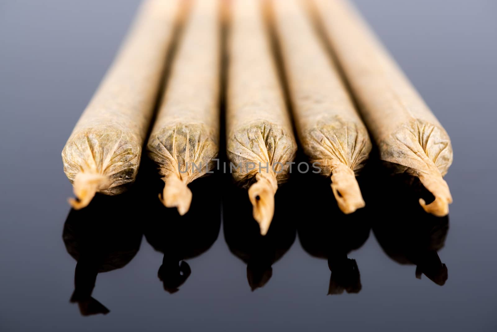 Medical Cannabis Marijuana Joints on Black Background, Close Up View.