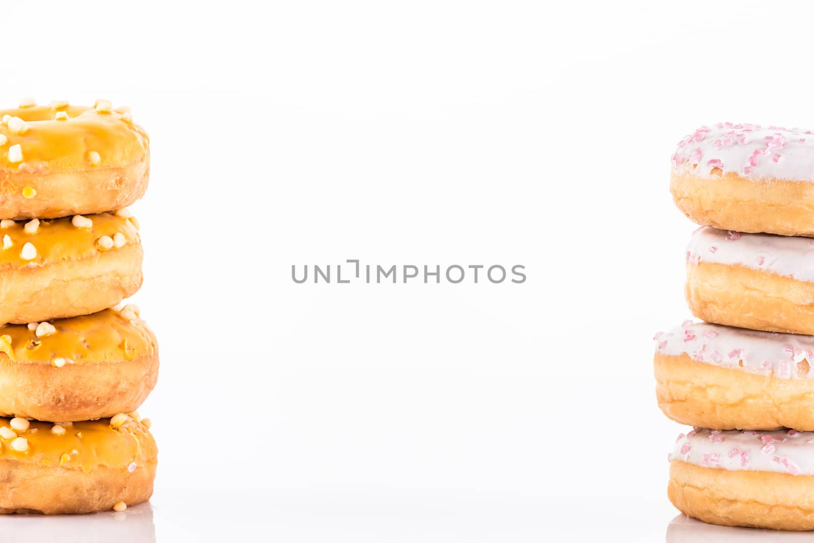 Donuts Tower Stack Pile on White Background. Food Border Background.