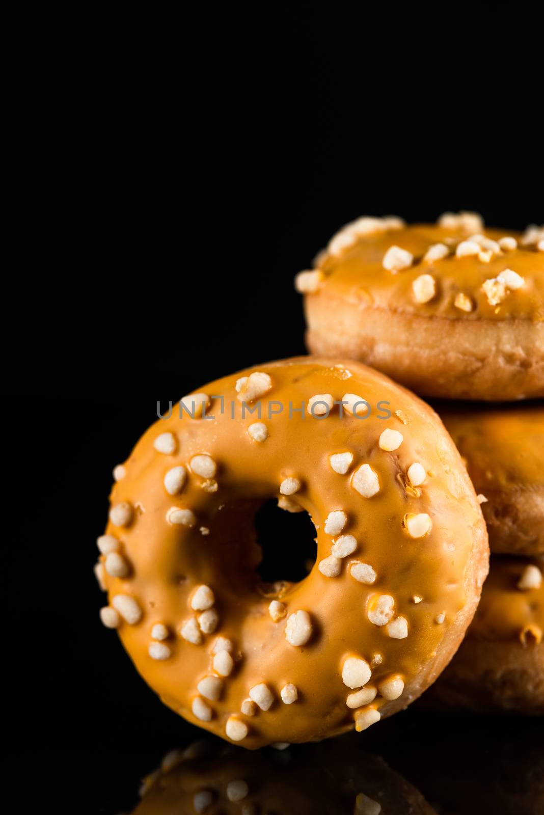 Salted Caramel Donuts or Doughnuts Tower on Dark Background. Cop by merc67