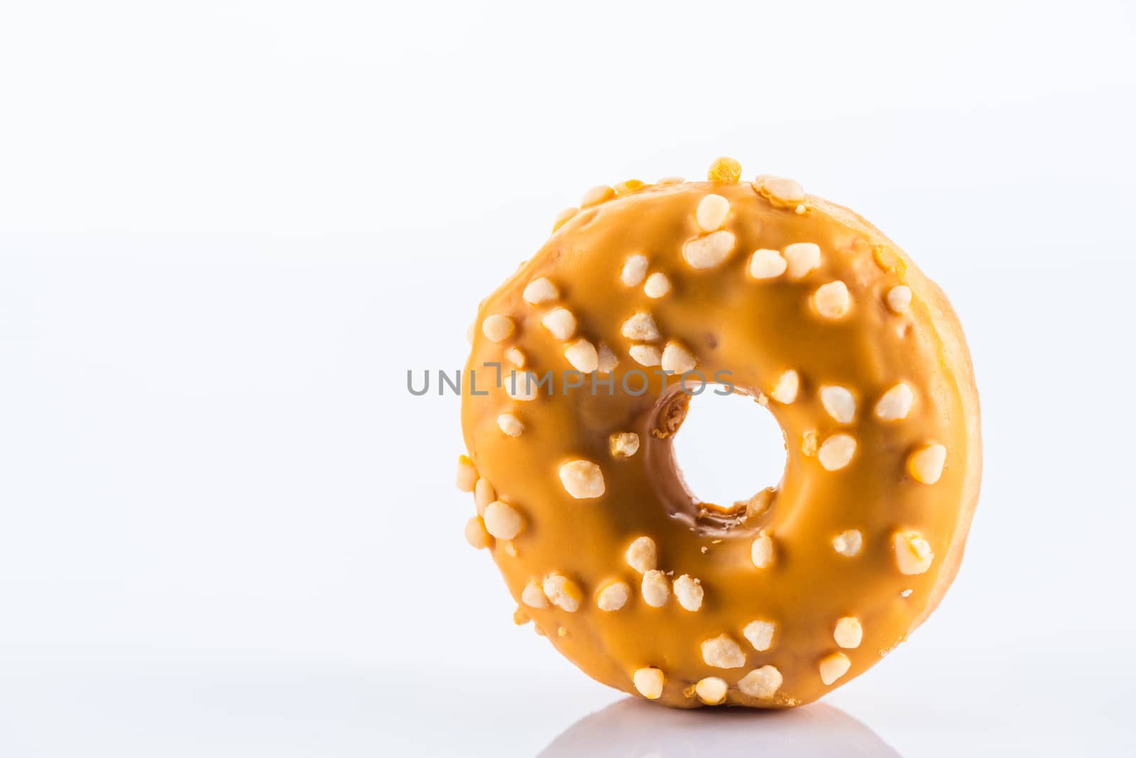 Single Salted Caramel Donut or Doughnut. Studio Photo on White Background, Close Up view.