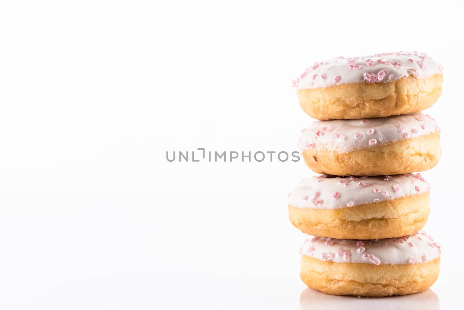 White Chocolate Donut or Doughnuts on White Reflective Background with Copy Space.