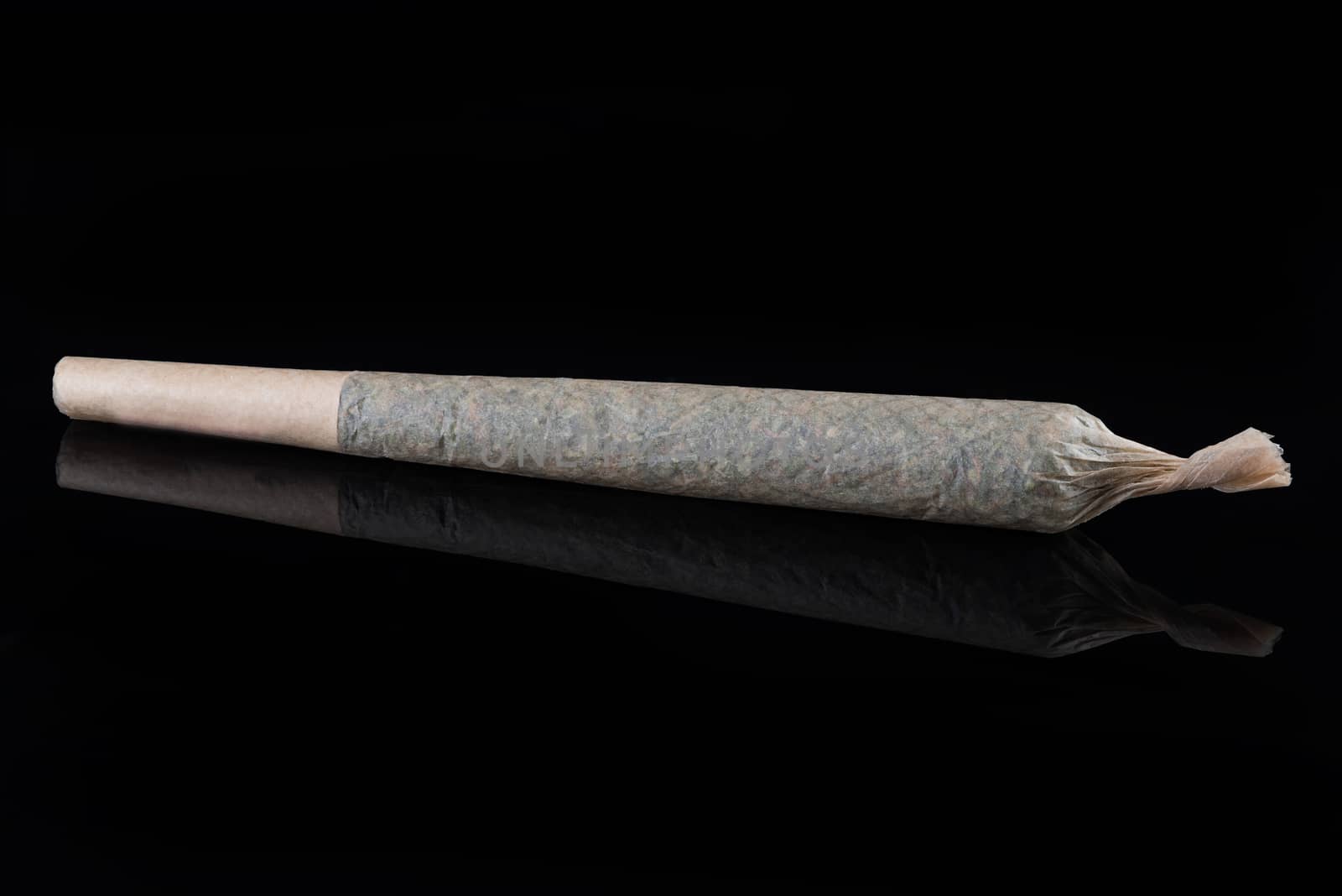 MEdical Marijuana Rolled Up Joint on Dark Background with Reflection.