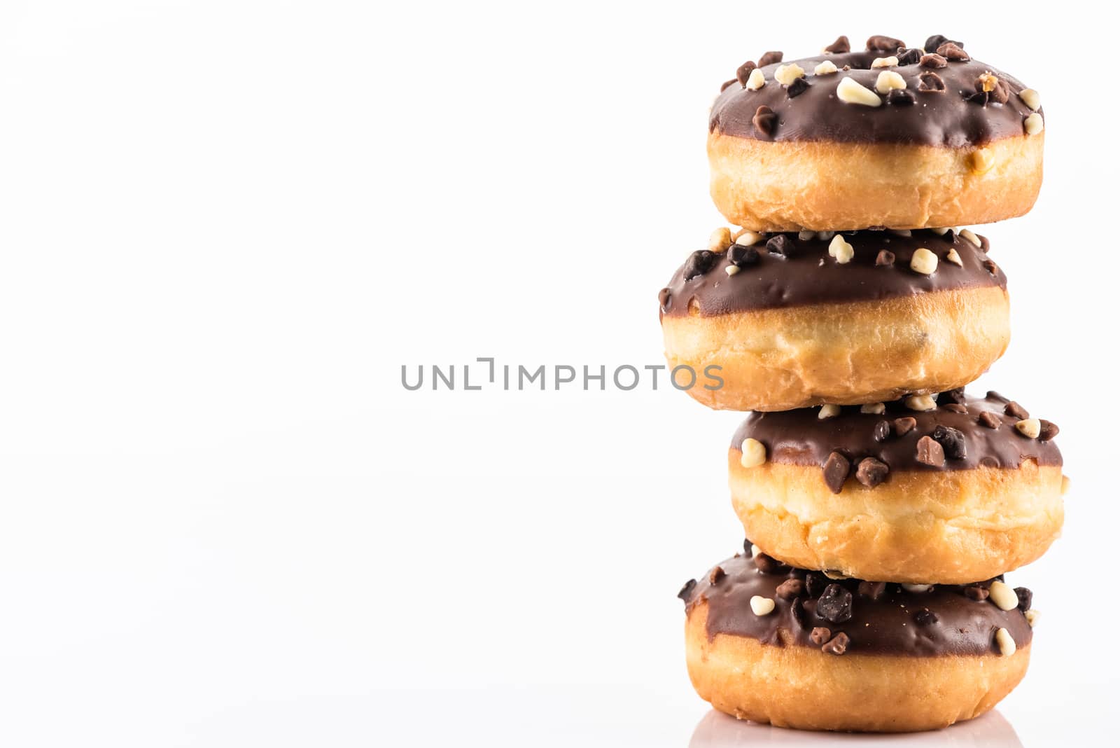 Chocolate and Peanuts Donut or Dougnut Tower on White Background.