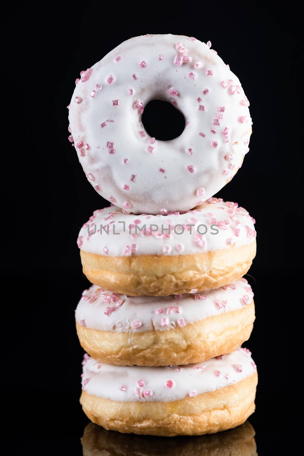 White Chocolate  Donuts or Doughnuts Tower on Dark Background. C by merc67