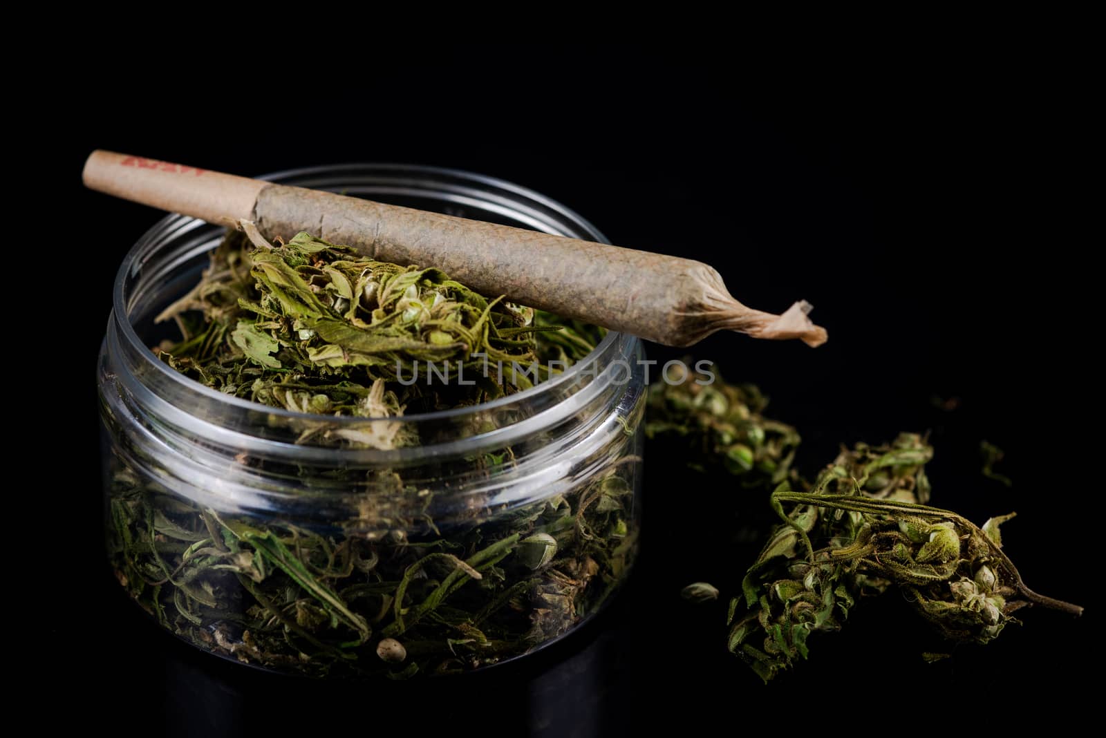 Prescription Medical Marijuana Joint and Cannabis Flower Buds in Jar. CBD and Cannabidiol Marijuana.