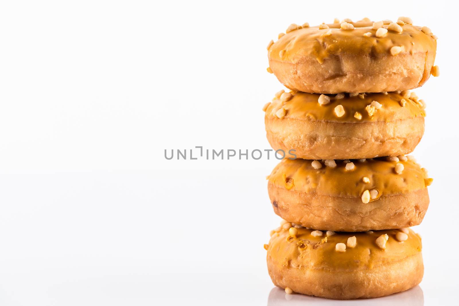 Salted Caramel Donut or Doughnuts on White Reflective Background with Copy Space.