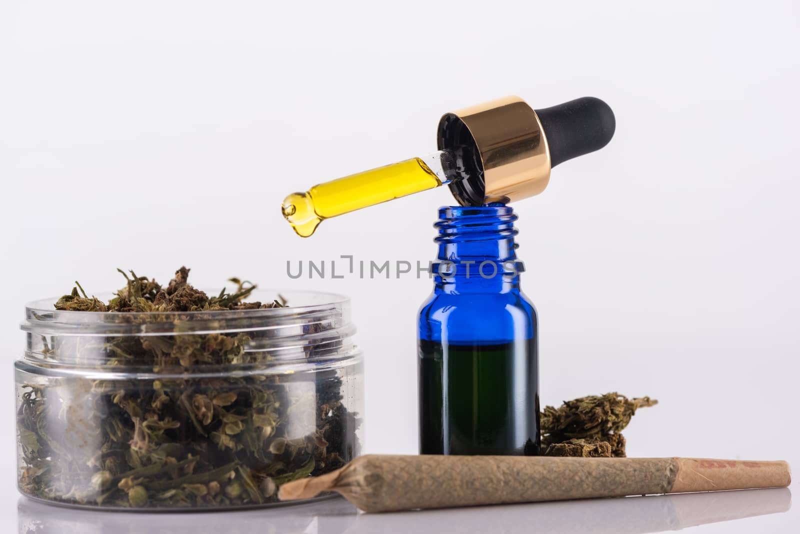 Cannabidiol Oil and Cannabis Flower Buds. Medical Marijuana Conceptual Image.