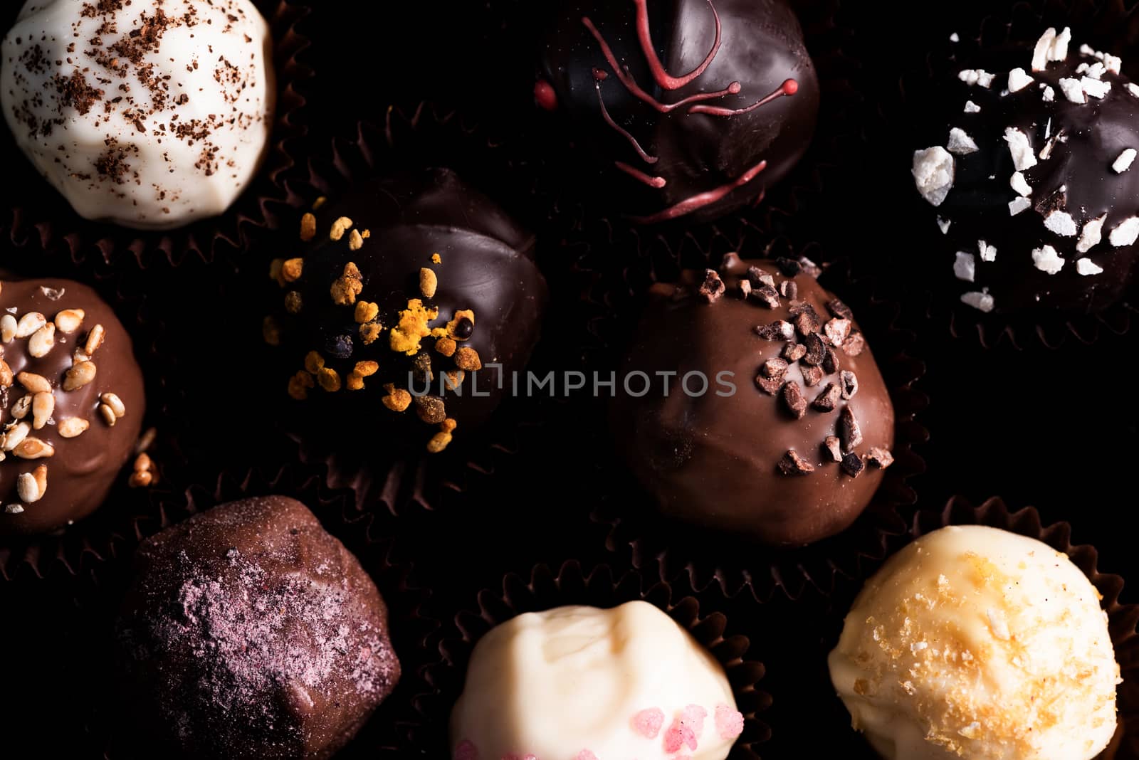 Chocolate Pralines Decorated by Hand. Close Up View on Details by merc67