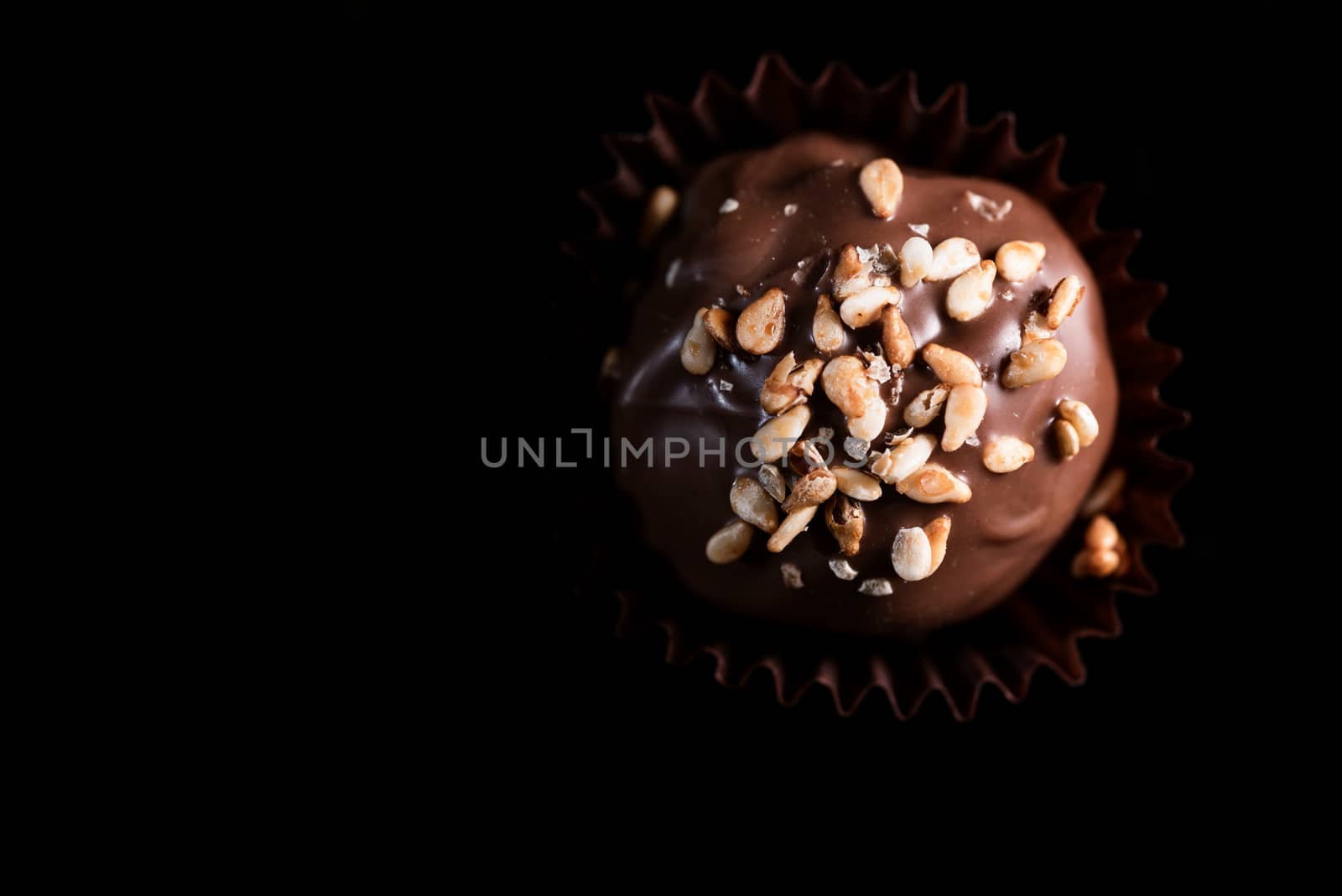 One Single Handmade Chocolate Praline Close Up View. Dark Backgr by merc67