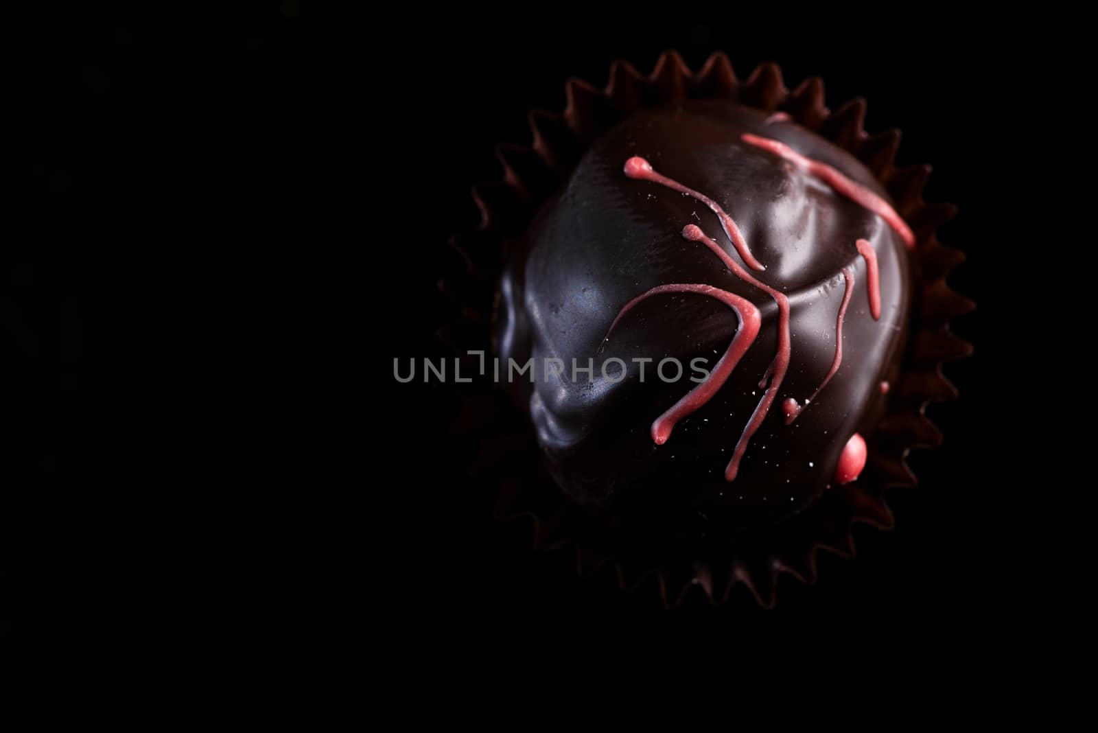 One Single Handmade Chocolate Praline Close Up View. Dark Backgr by merc67