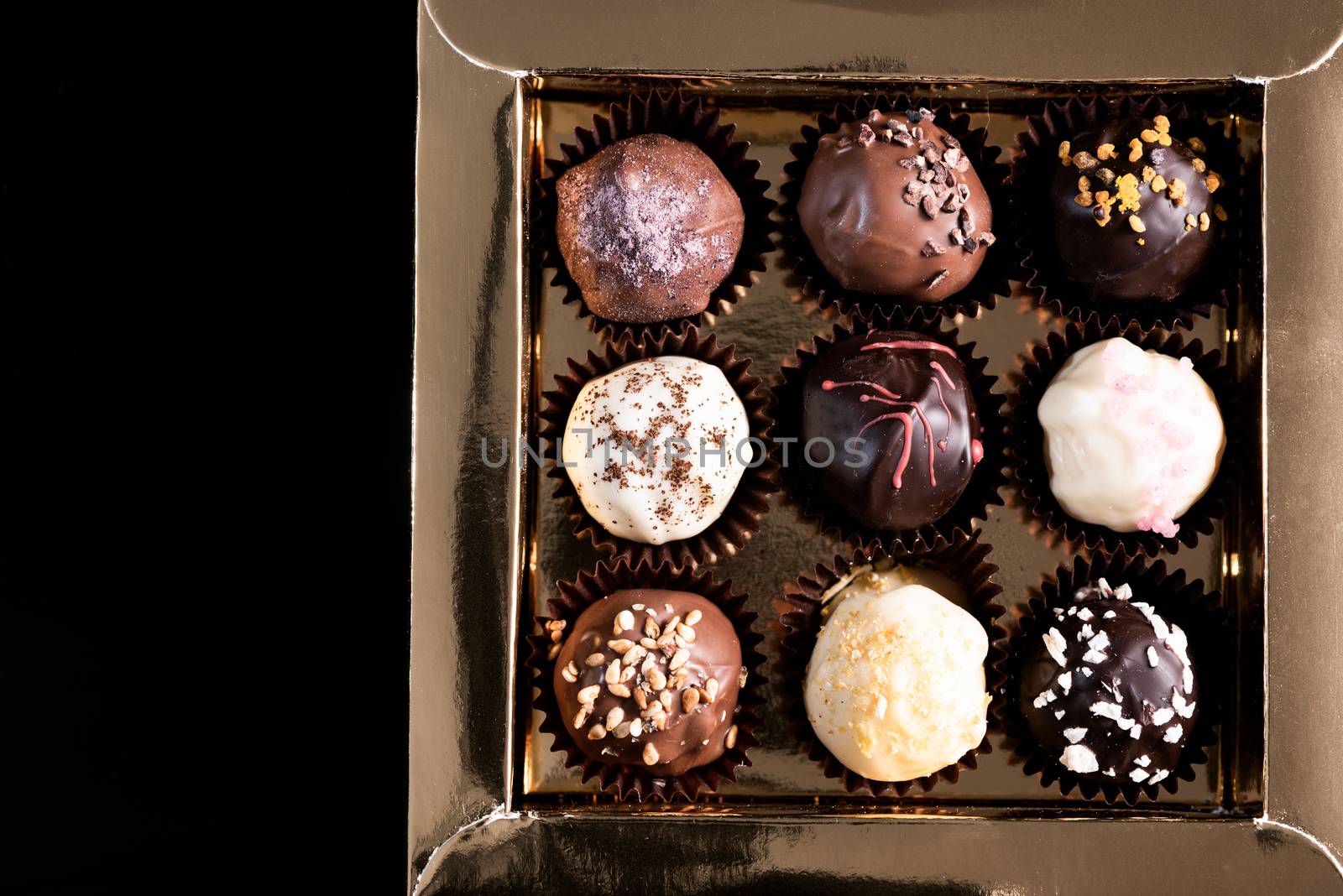 Box with Chocolate Pralines on dark Background. Copy Space by merc67