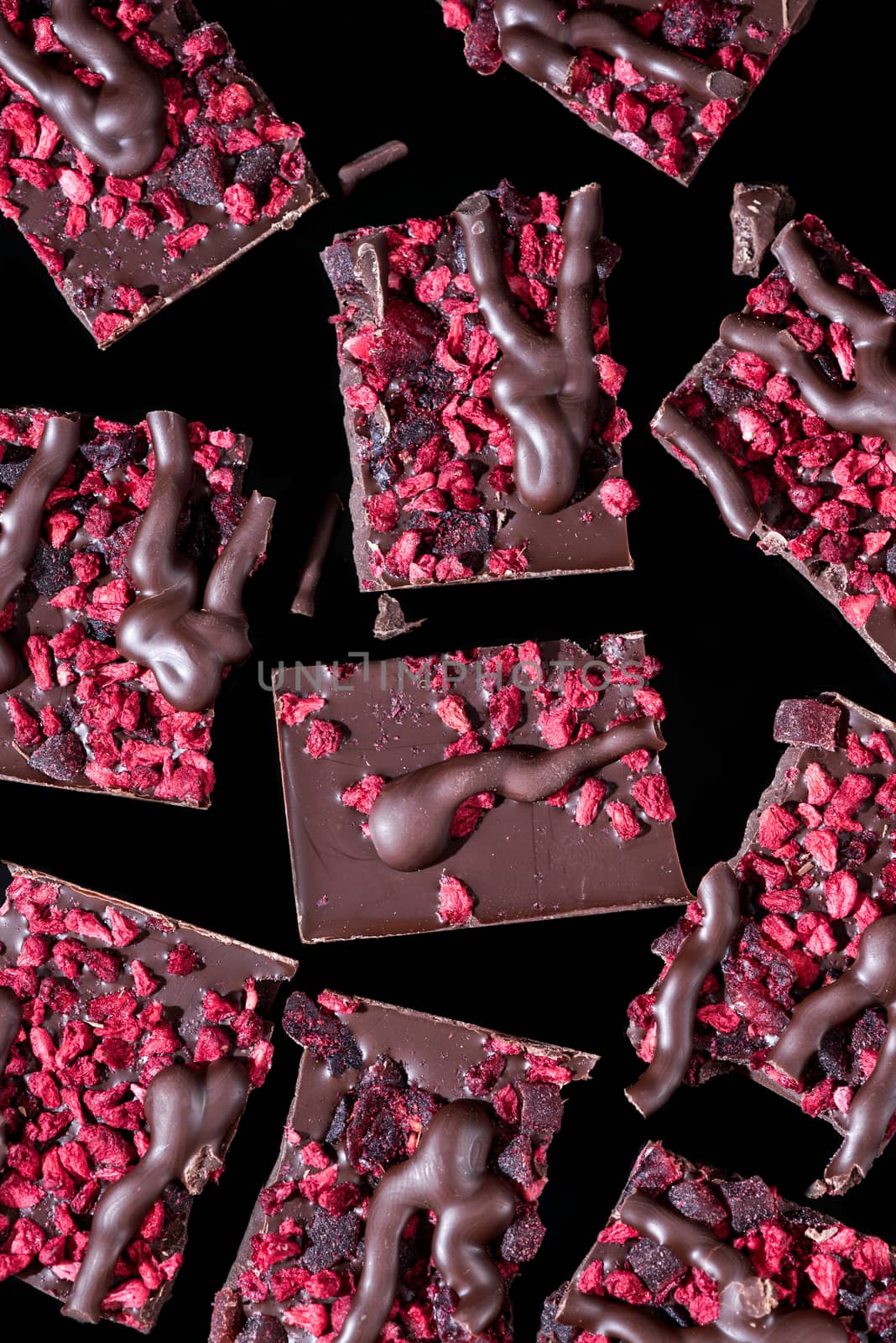 Broken Pieces of Chocolate Bar on Dark Background. Close Up View.