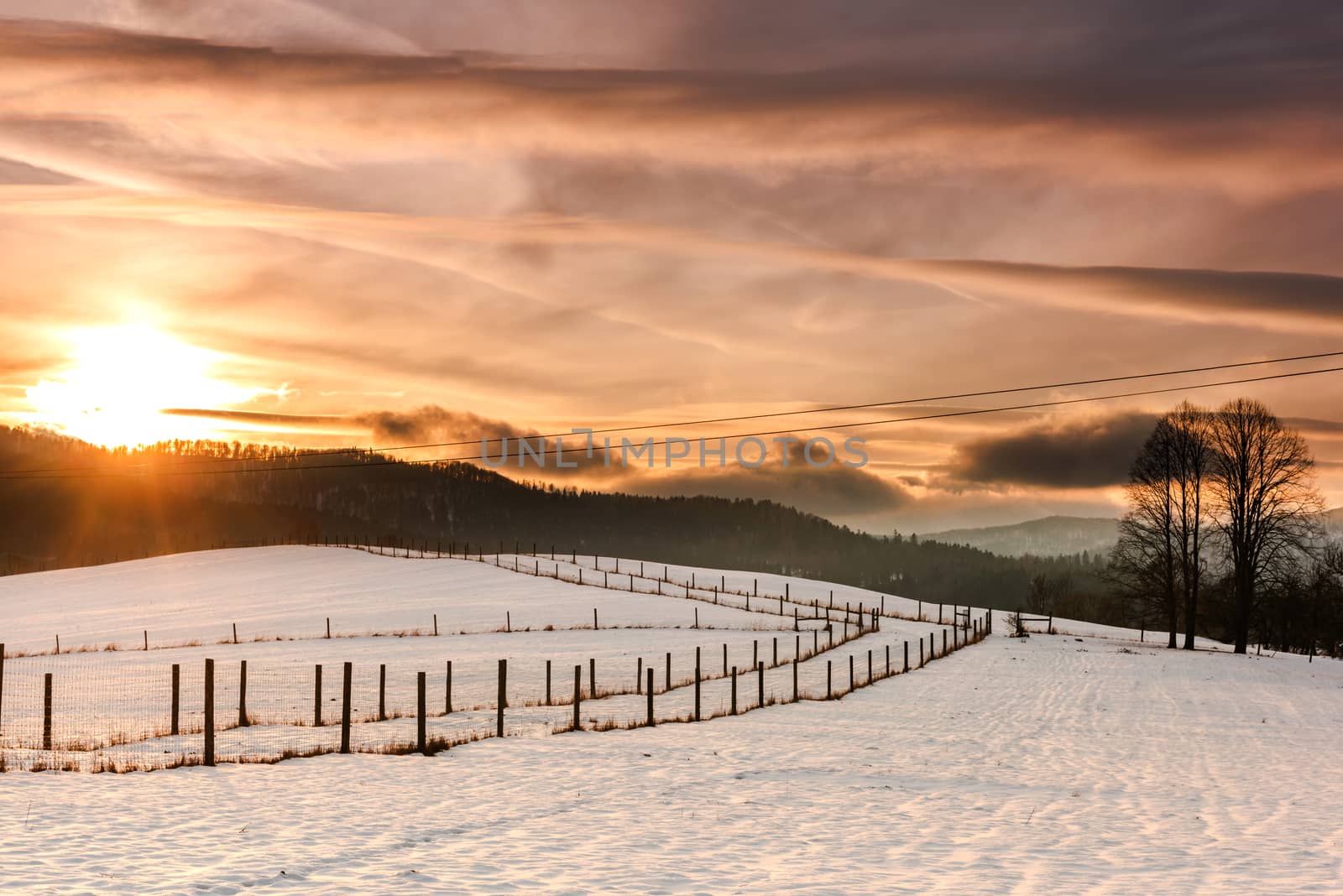 Beautiful Sunset over Snow Covered Farmland and Fields in Bieszc by merc67