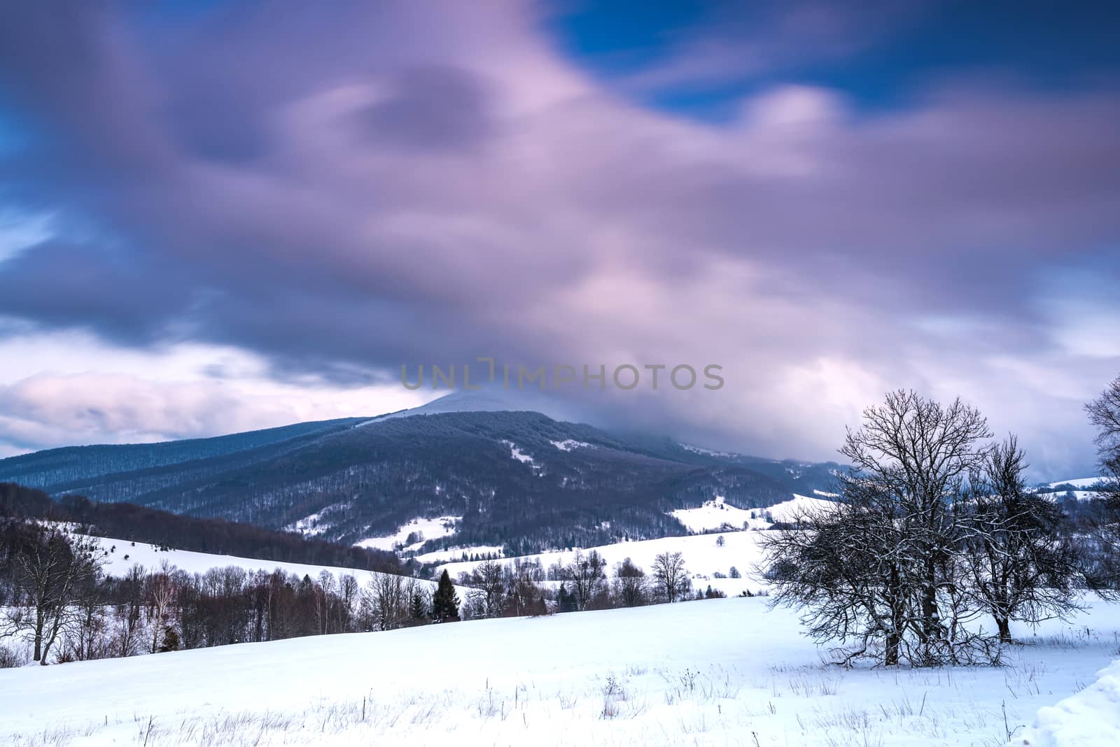 Sunrise in Bieszczady Mountains in Winter. Long Exposure. Snowy Hills and Meadows.