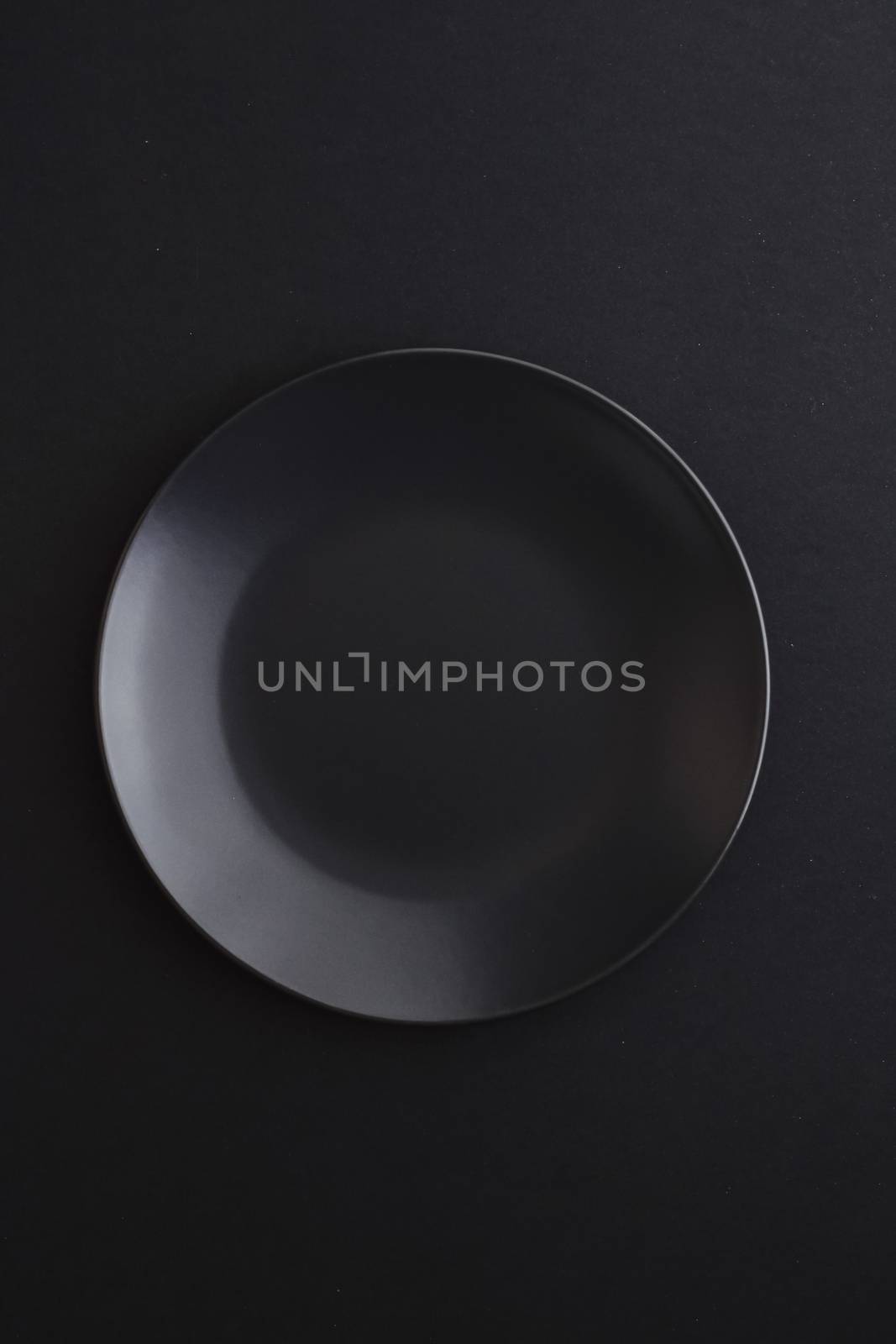 Empty plates on black background, premium dishware for holiday dinner, minimalistic design and diet concept