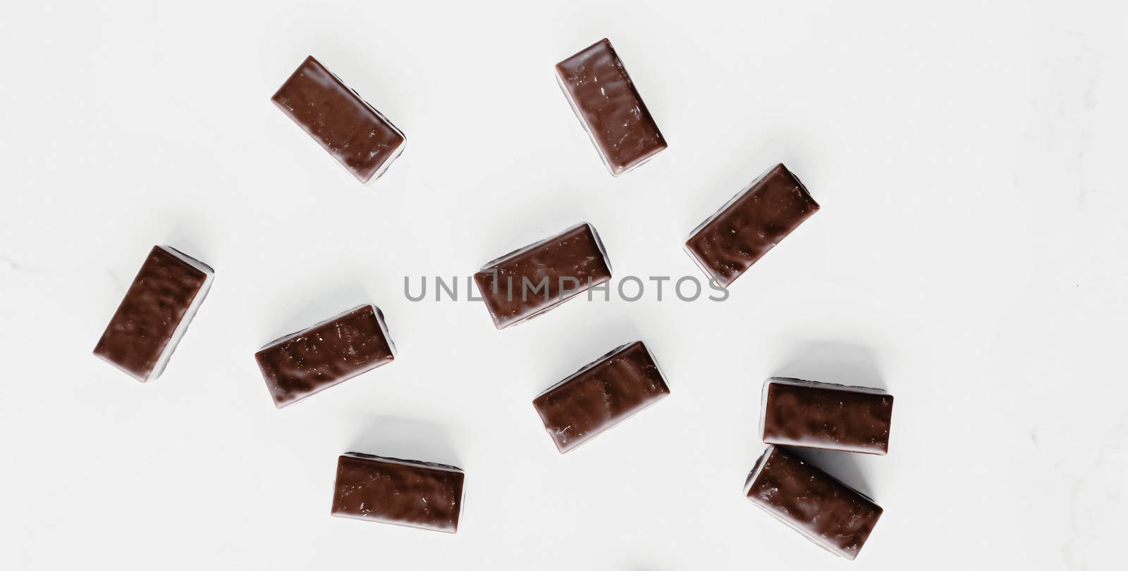 Dark chocolate candies isolated on white background, sweet food and dessert by Anneleven