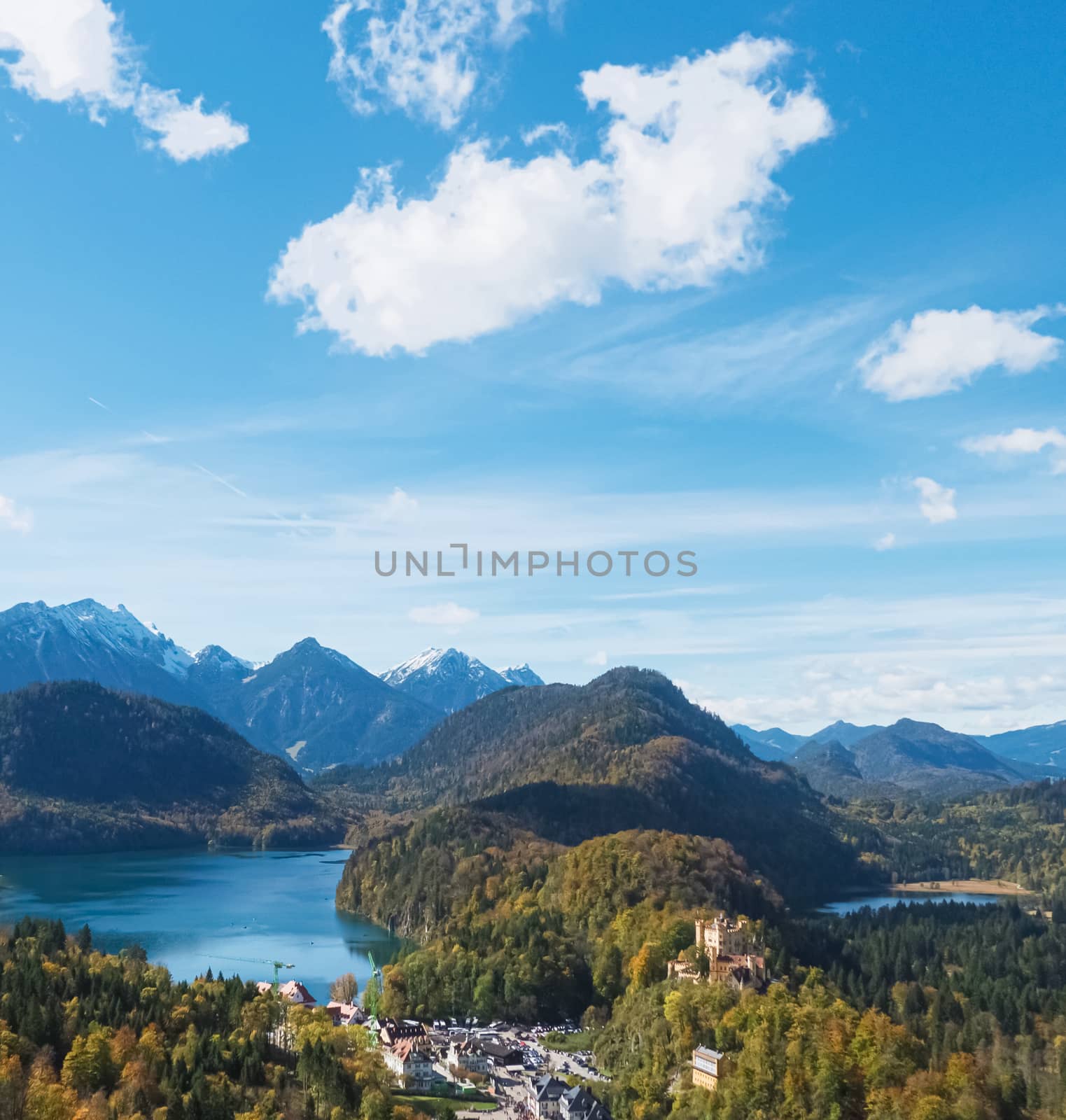 Beautiful nature of European Alps, landscape view of alpine mountains, lake and village on a sunny day, travel and destination scenery