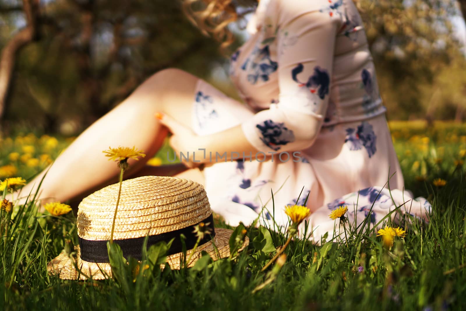 Woman with a straw hat in a flower field. Focus on hat by natali_brill