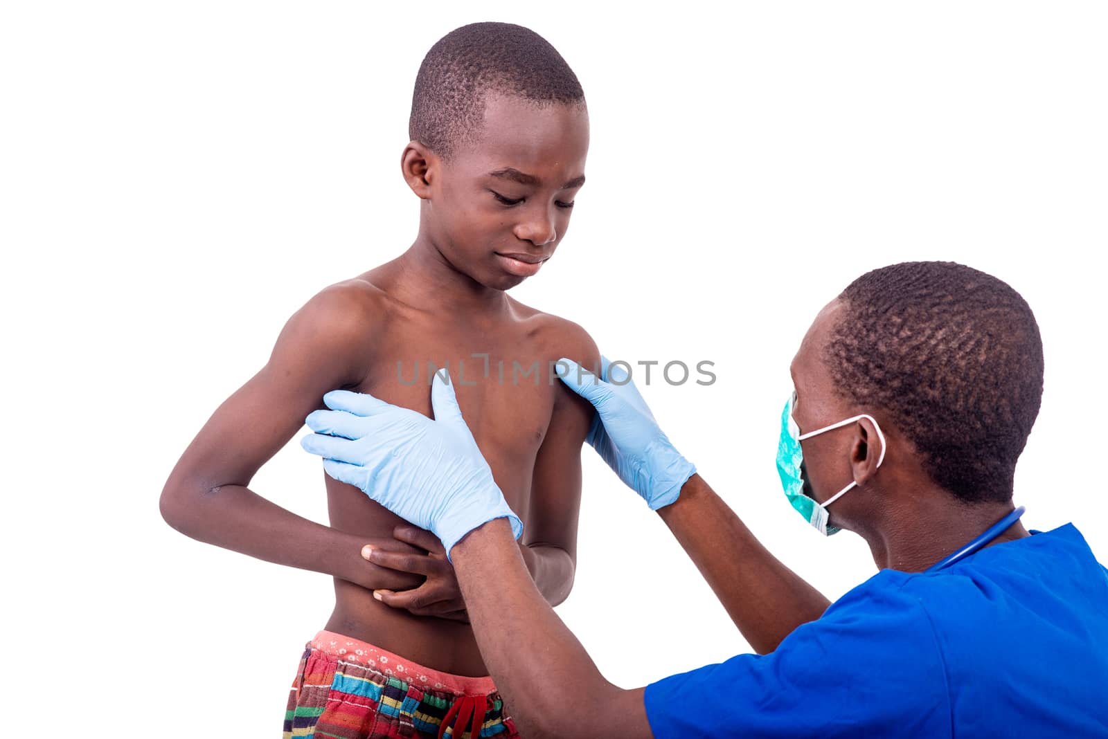 young male doctor in uniform examining a little boy.