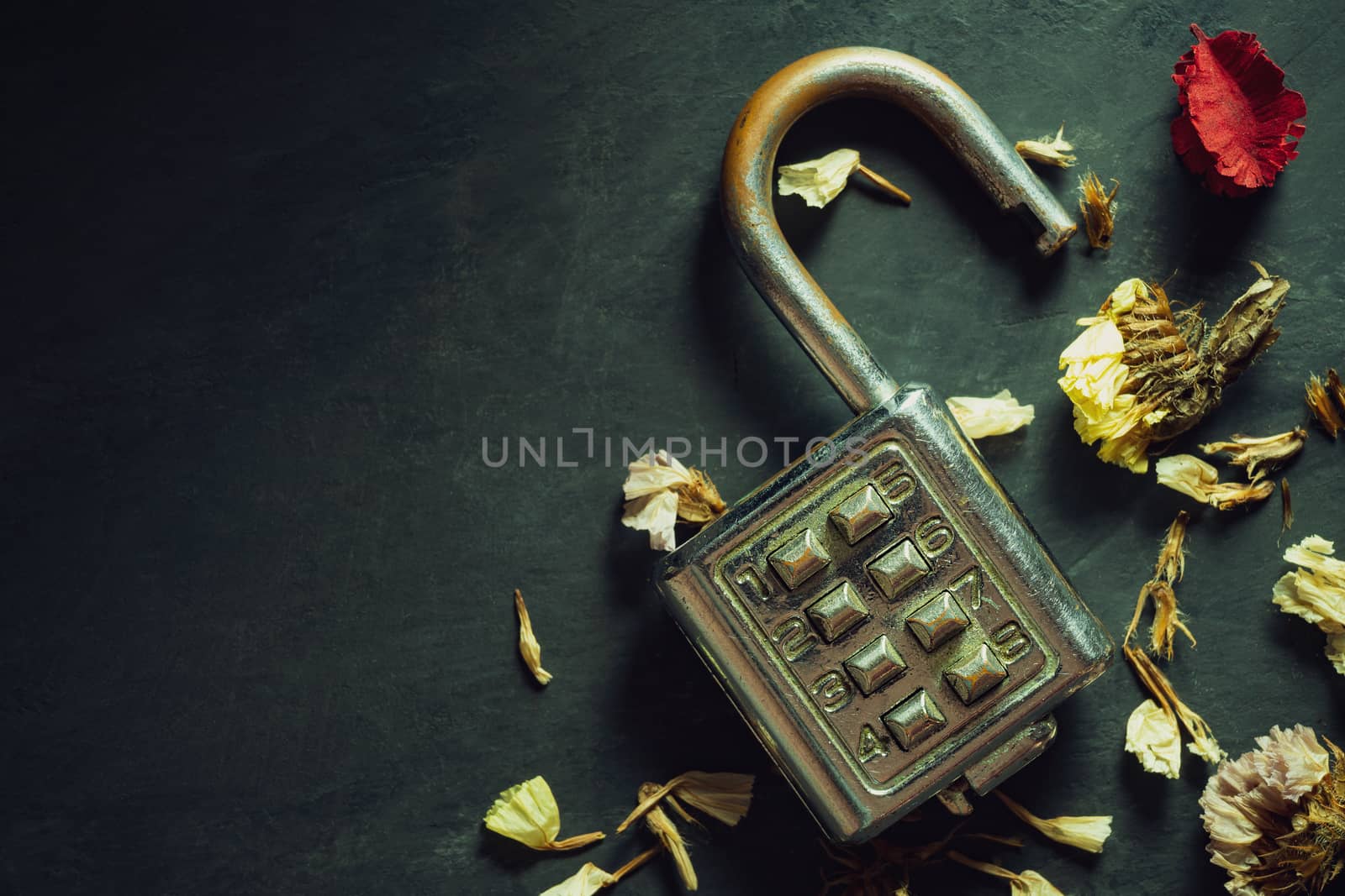 Combination padlock on blackboard background. Top view and copy space. Concept of safety and secret in vintage style.