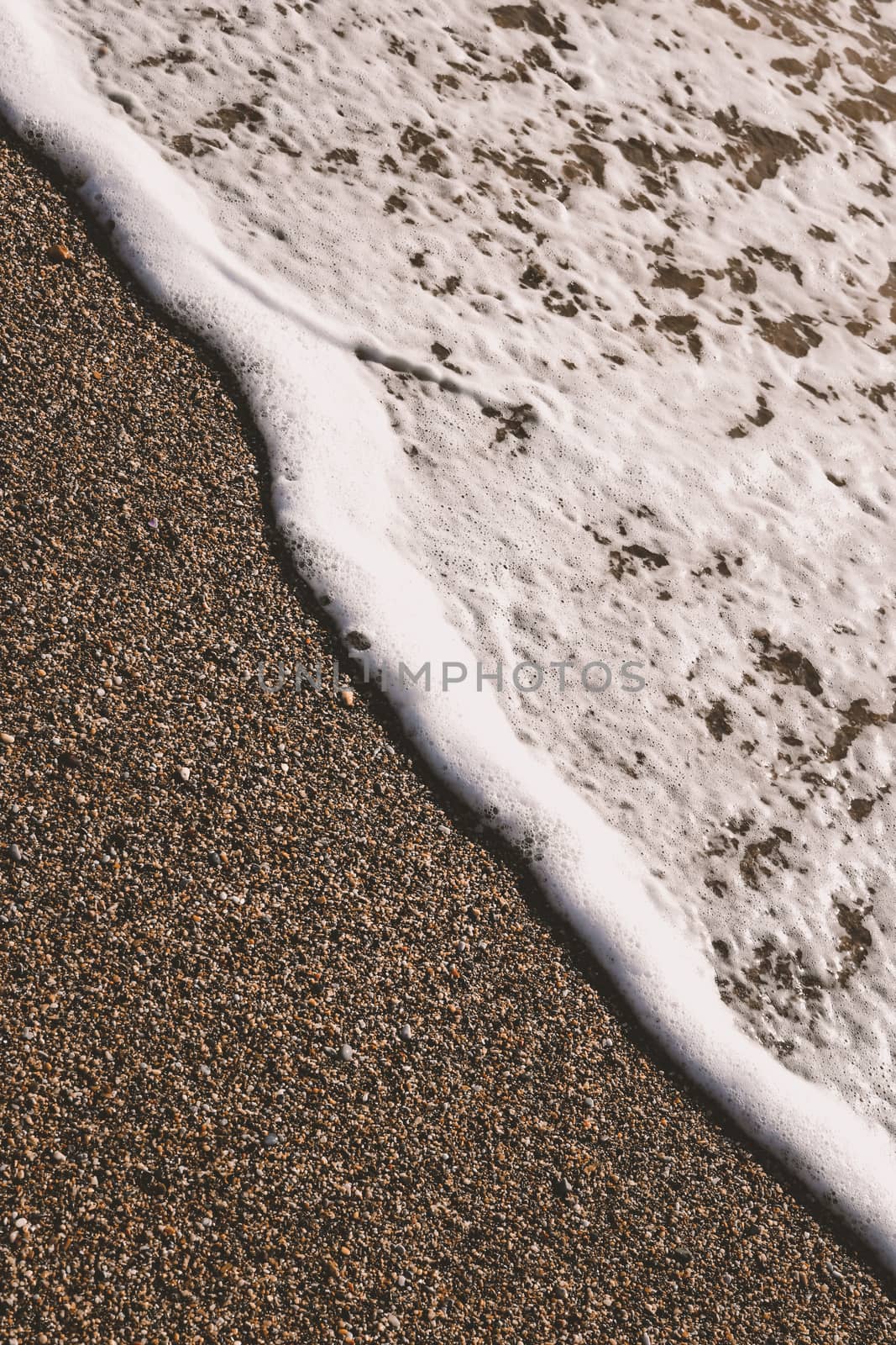 Beach sand with sea wave foam background