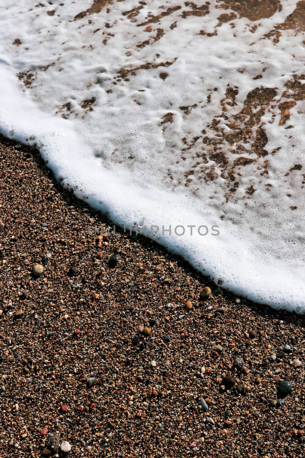 Sea wave foam on the beach sand. Marine summer background. by sanches812