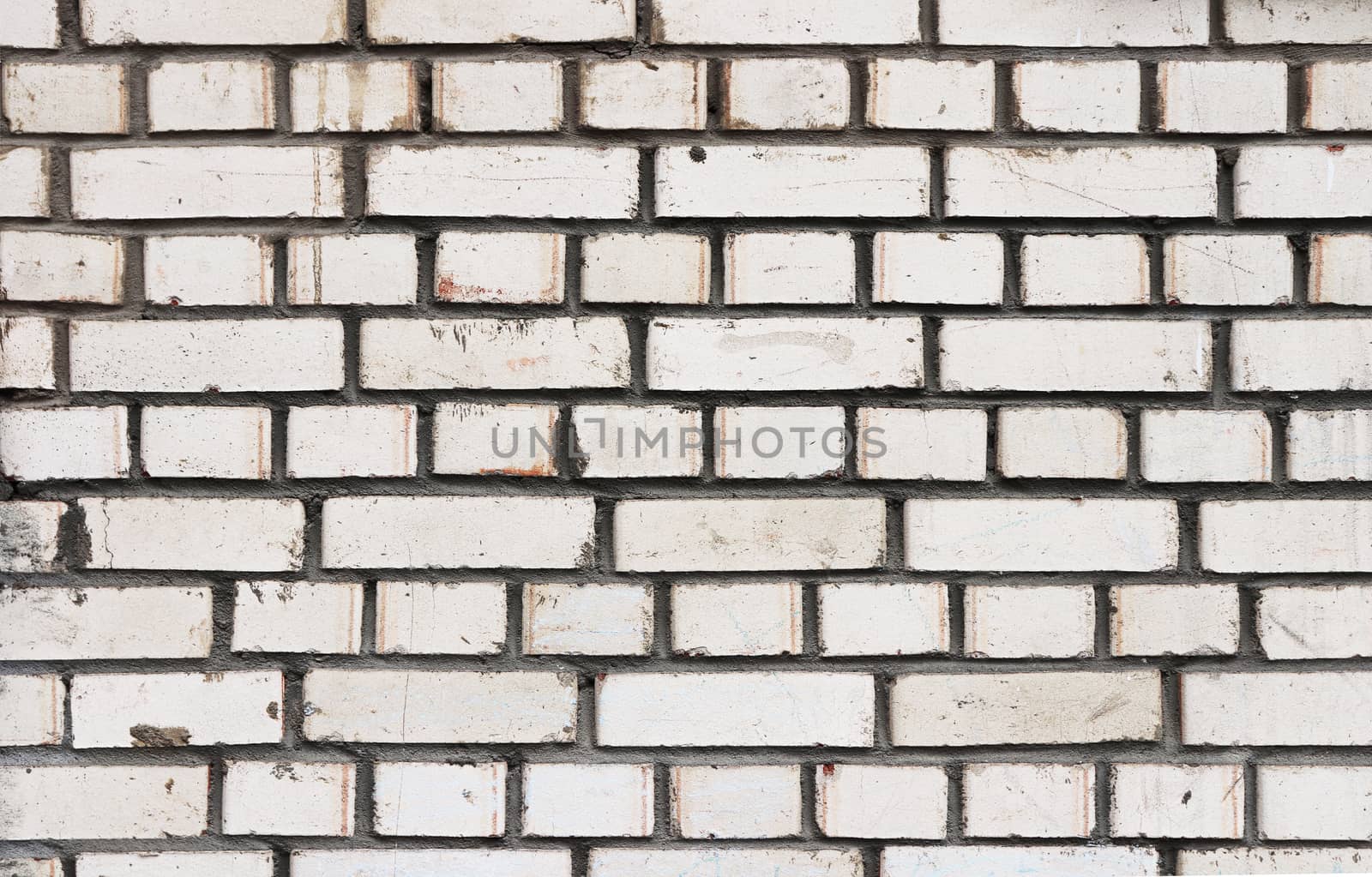 White bricks wall texture with cement stains. 