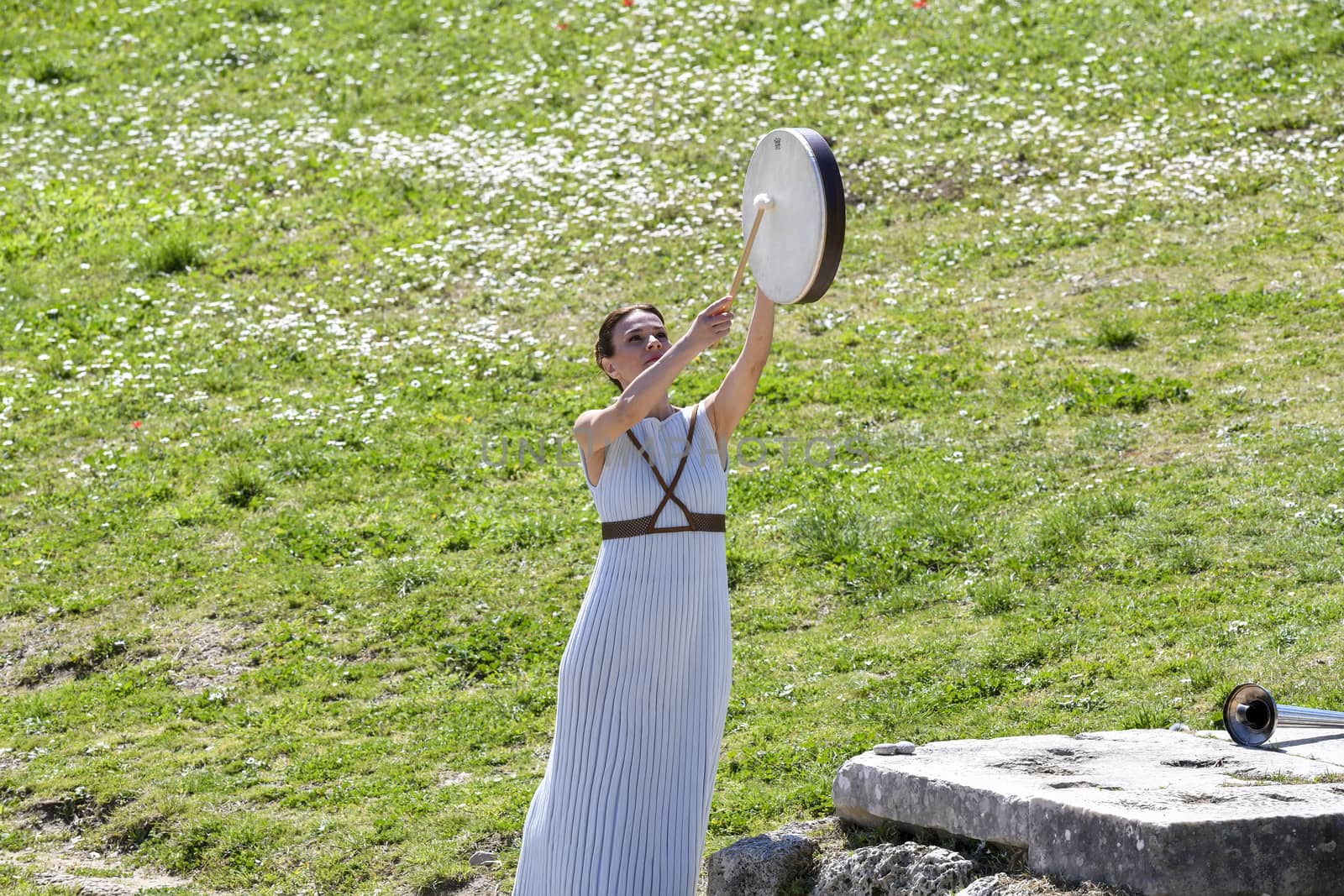 Olympia, Greece -  March 12, 2020: Olympic Flame handover ceremony for the Tokyo 2020 Summer Olympic Games at the Ancient Olympia site, birthplace of the ancient Olympics in southern Greece.