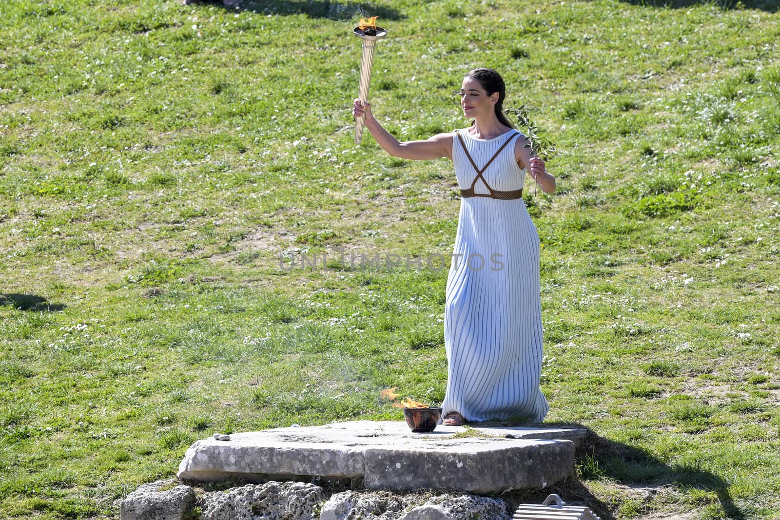 Olympia, Greece -  March 12, 2020: Olympic Flame handover ceremony for the Tokyo 2020 Summer Olympic Games at the Ancient Olympia site, birthplace of the ancient Olympics in southern Greece.