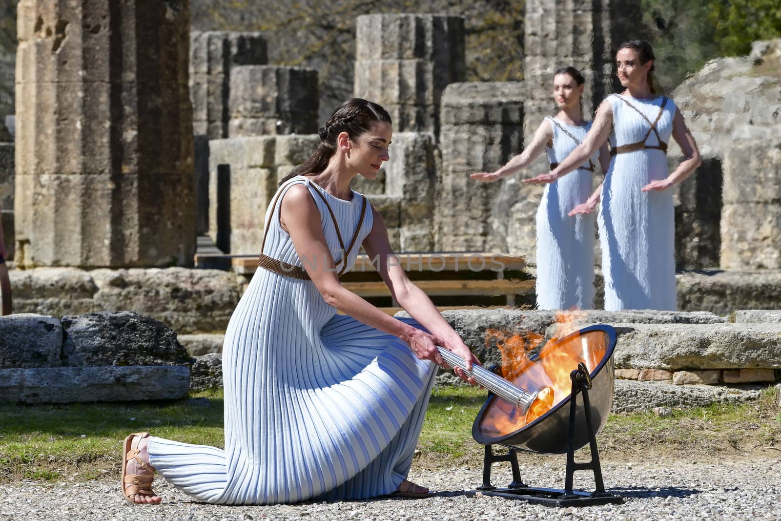 Olympia, Greece -  March 12, 2020: Olympic Flame handover ceremony for the Tokyo 2020 Summer Olympic Games at the Ancient Olympia site, birthplace of the ancient Olympics in southern Greece.