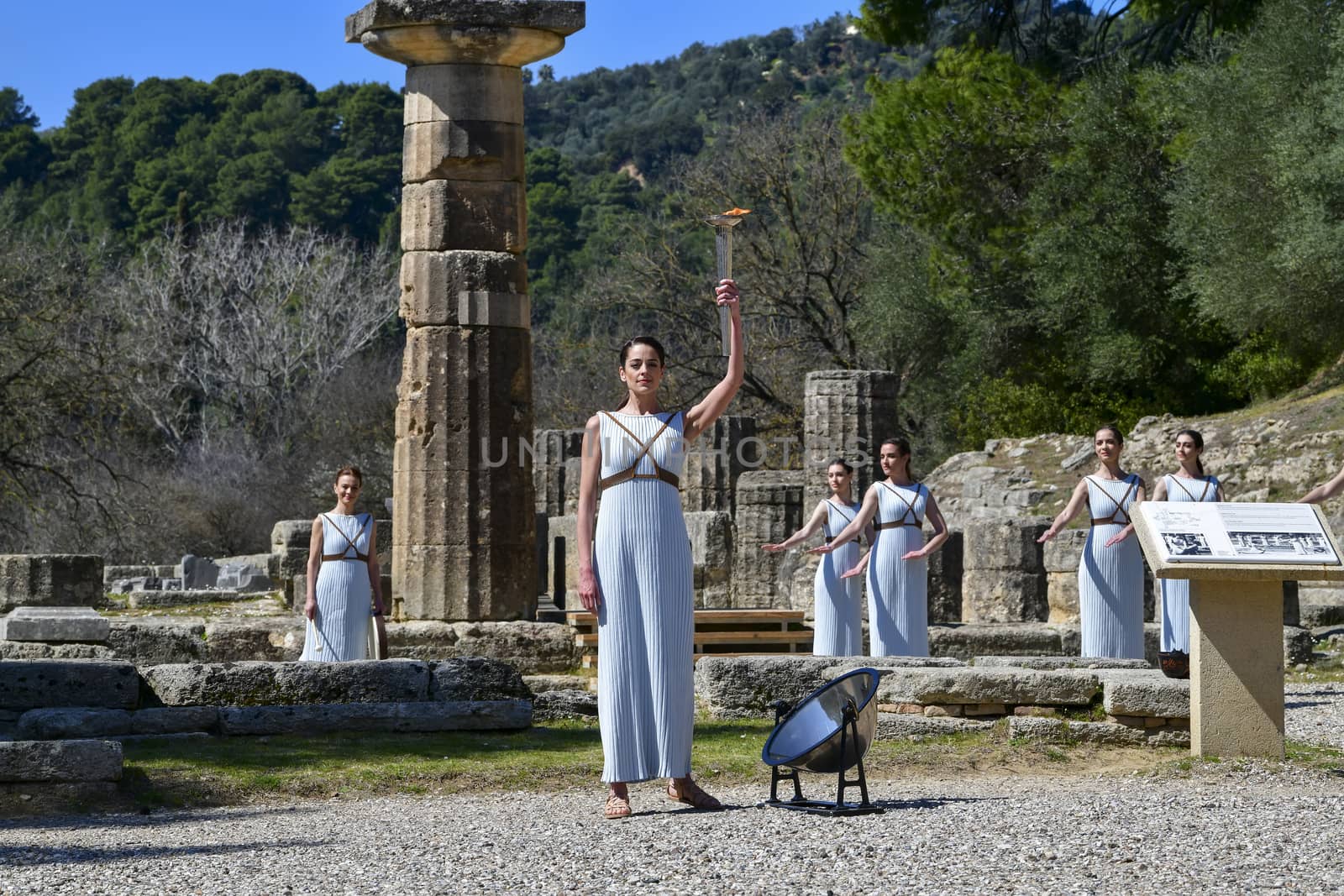 Olympia, Greece -  March 12, 2020: Olympic Flame handover ceremony for the Tokyo 2020 Summer Olympic Games at the Ancient Olympia site, birthplace of the ancient Olympics in southern Greece.