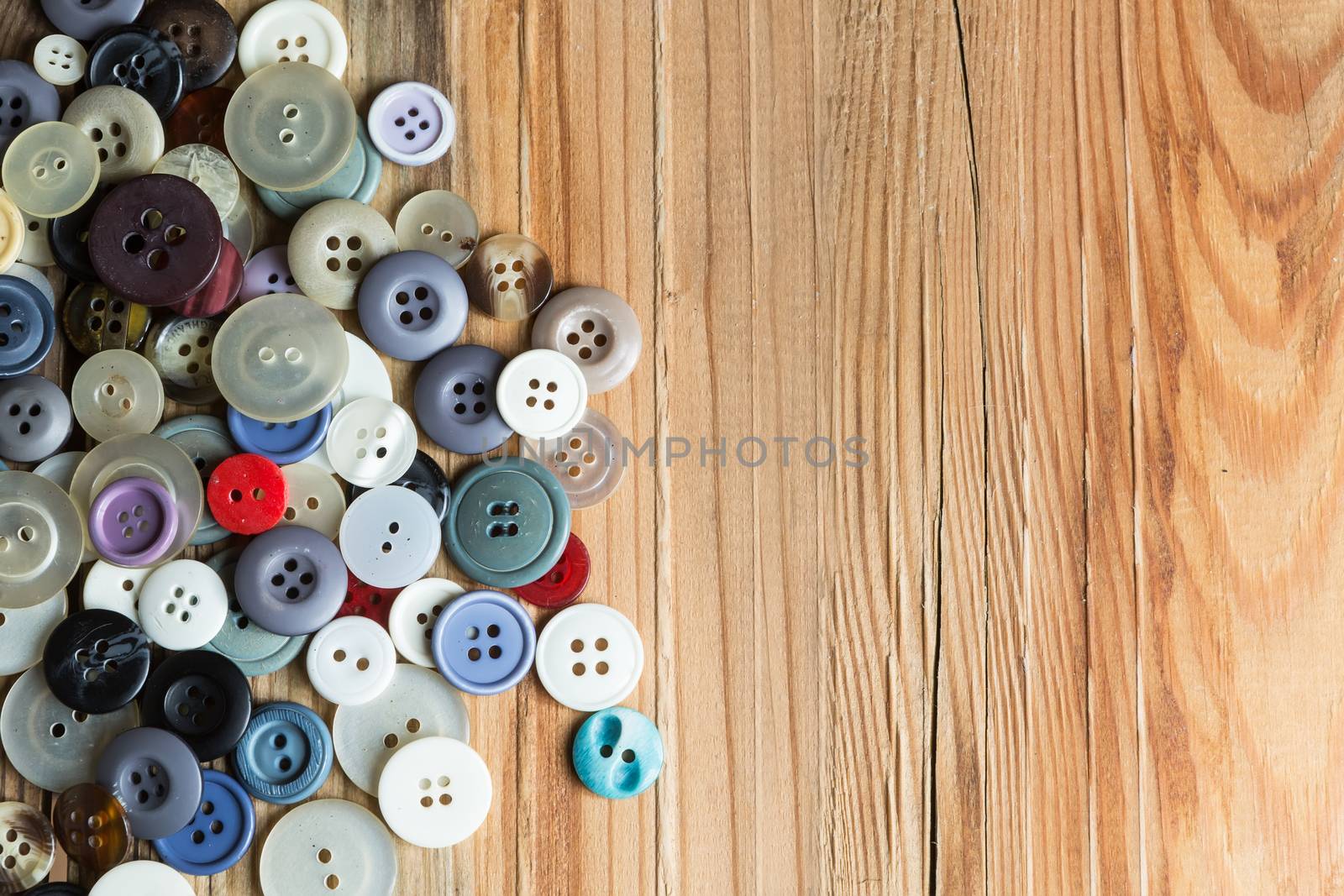 colored buttons on wooden board, Colorful buttons, on old wooden by ververidis