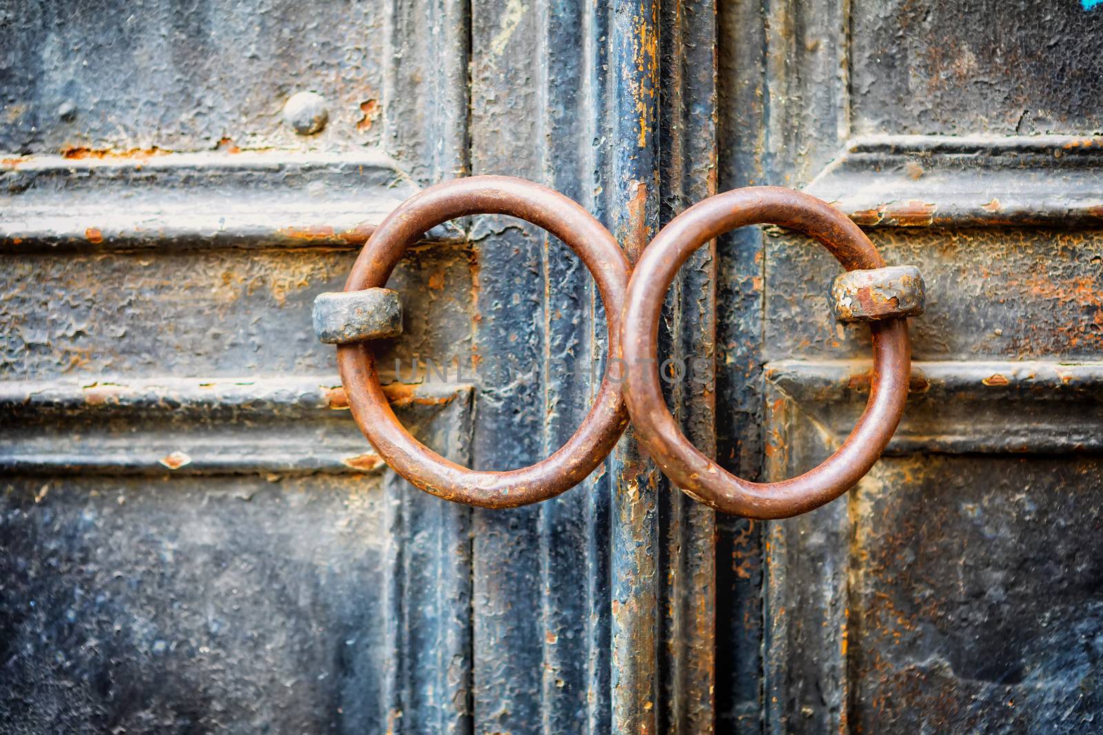 Closeup of metal vintage door with metal door handle, selective focus, image cross processed for vintage look