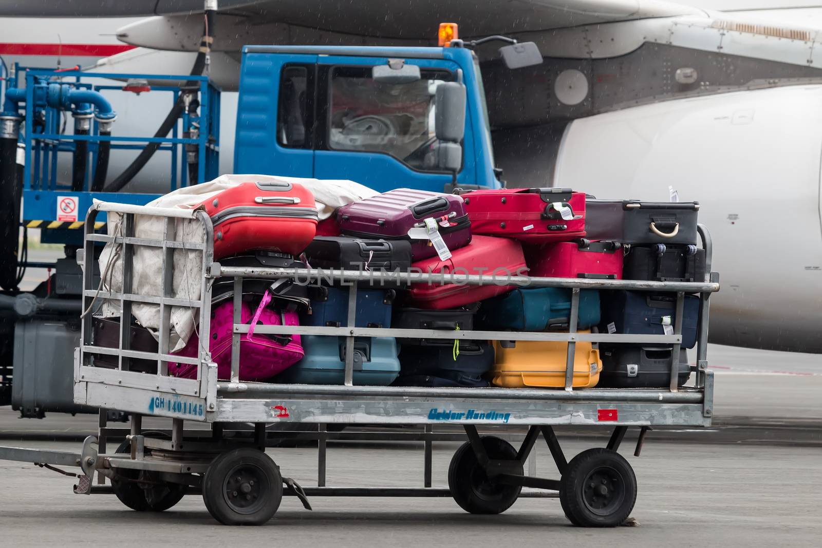  luggage cart on the runway of the airport Macedonia a rainy day by ververidis