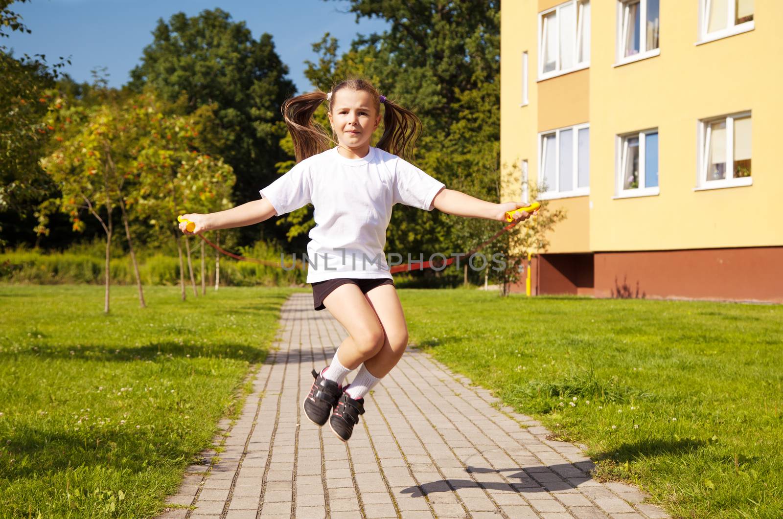 little girl jumping rope outside by raddnatt