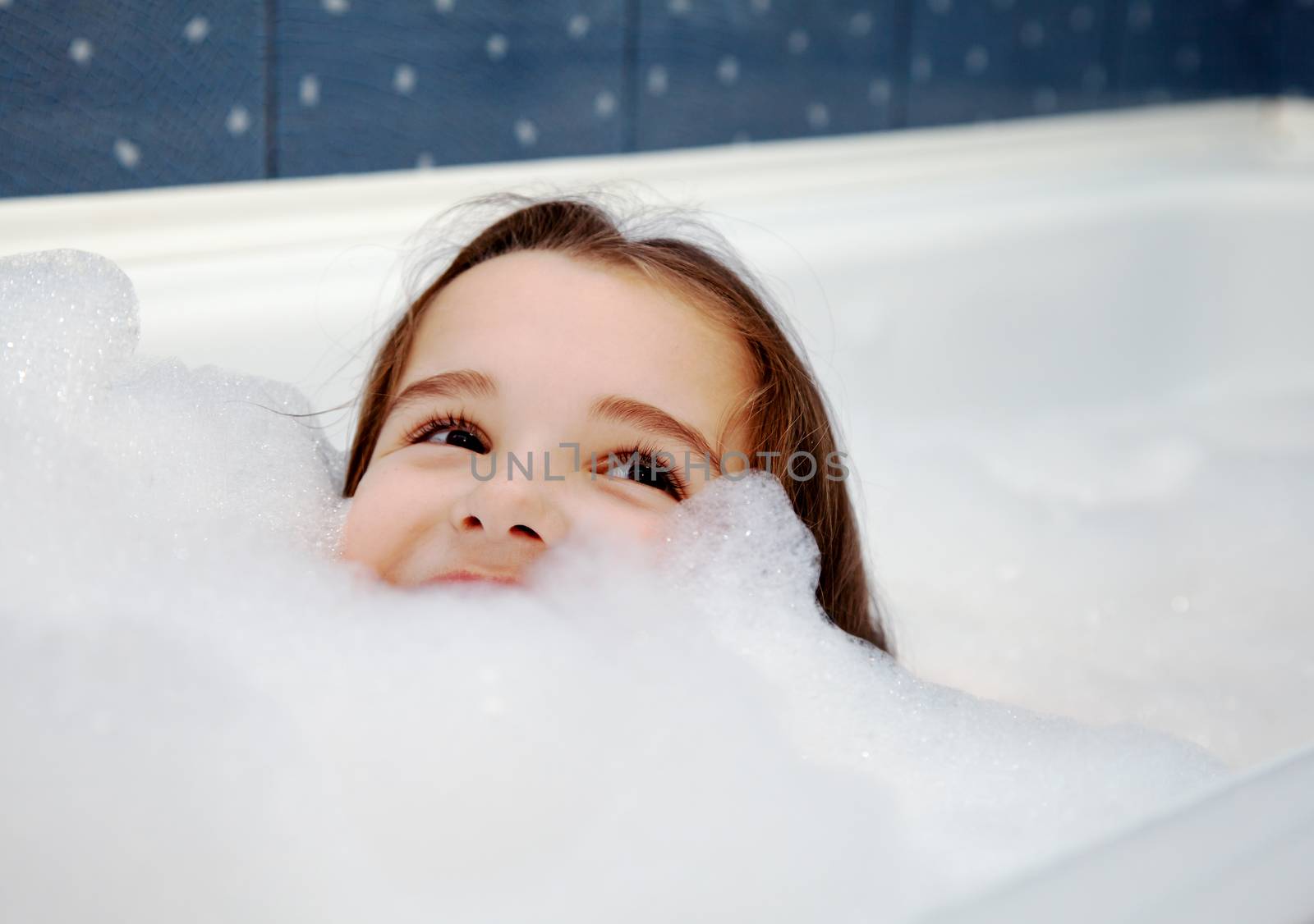 little smiling girl washing in bath closeup