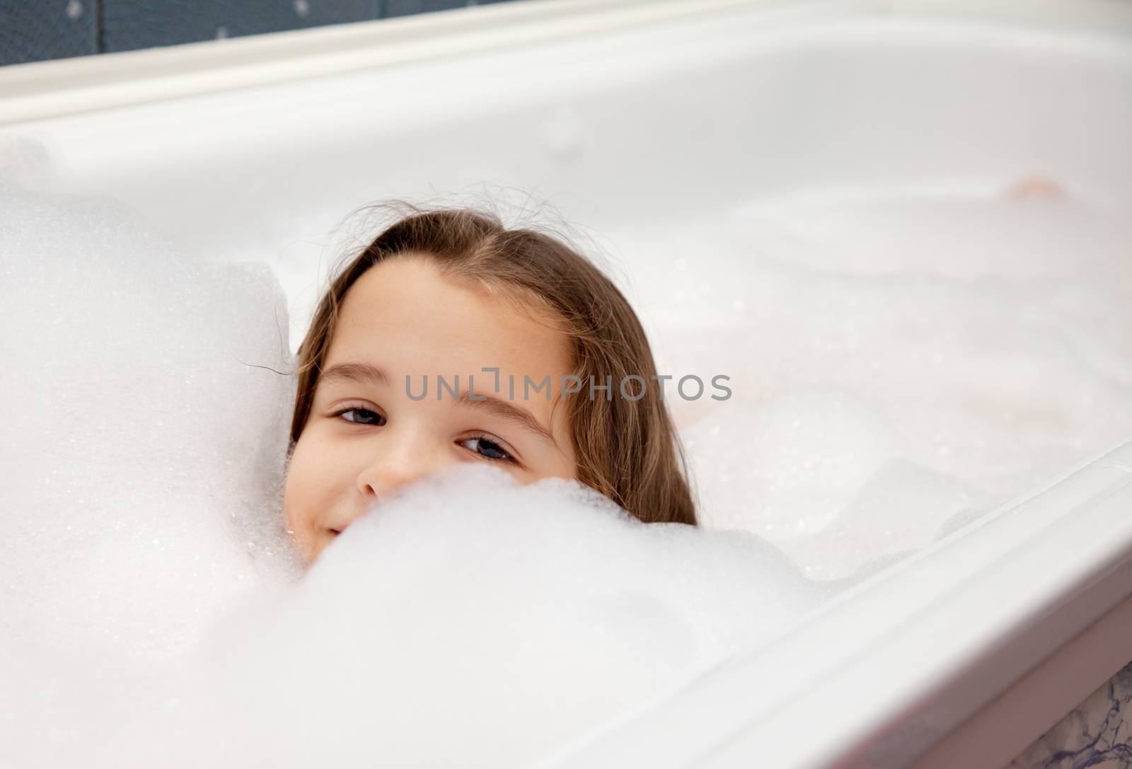 little girl washing in bath closeup