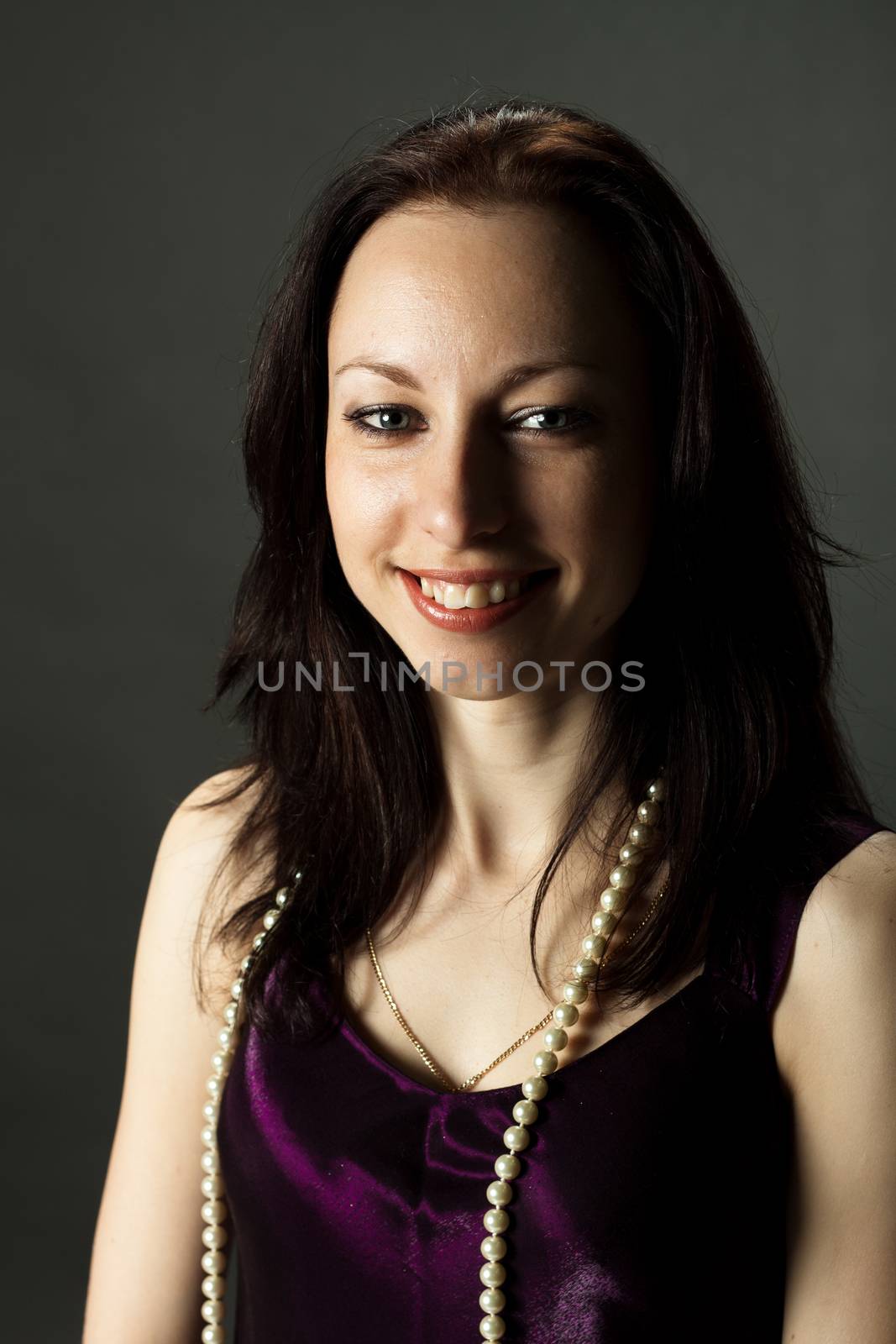 portrait of pretty young smiling woman in vinous dress