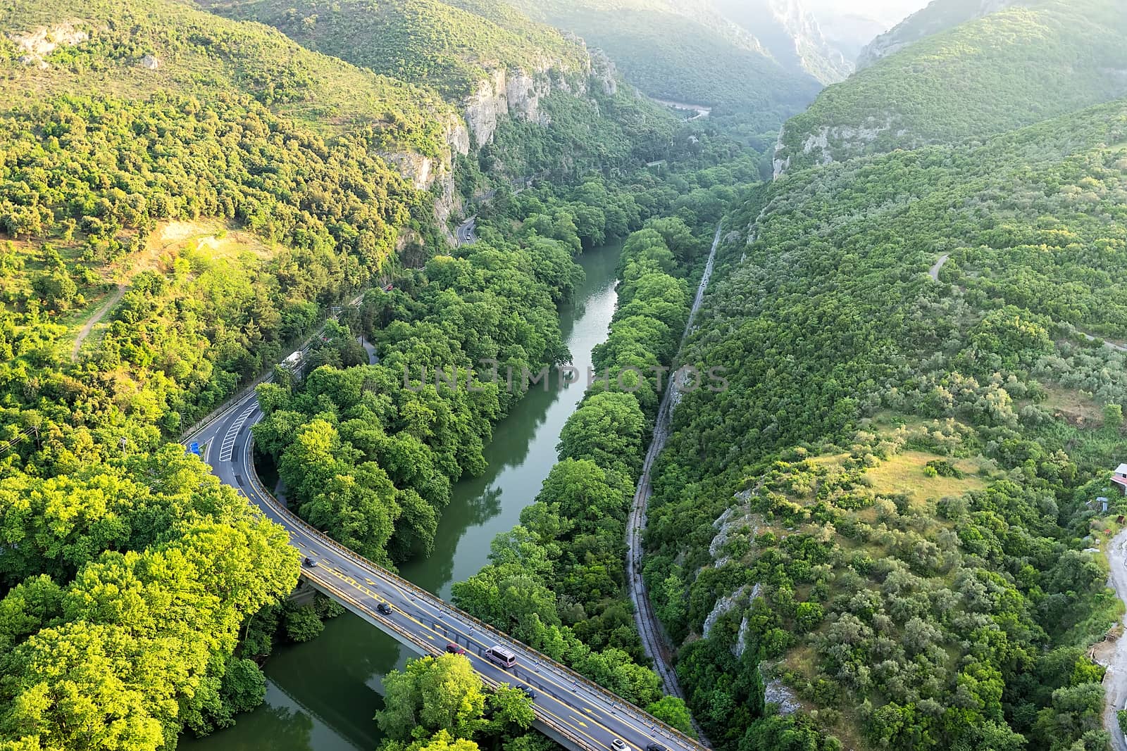 Aerial view of the bridge and the road over the river Pinios in the green valley of Tempe in Greece