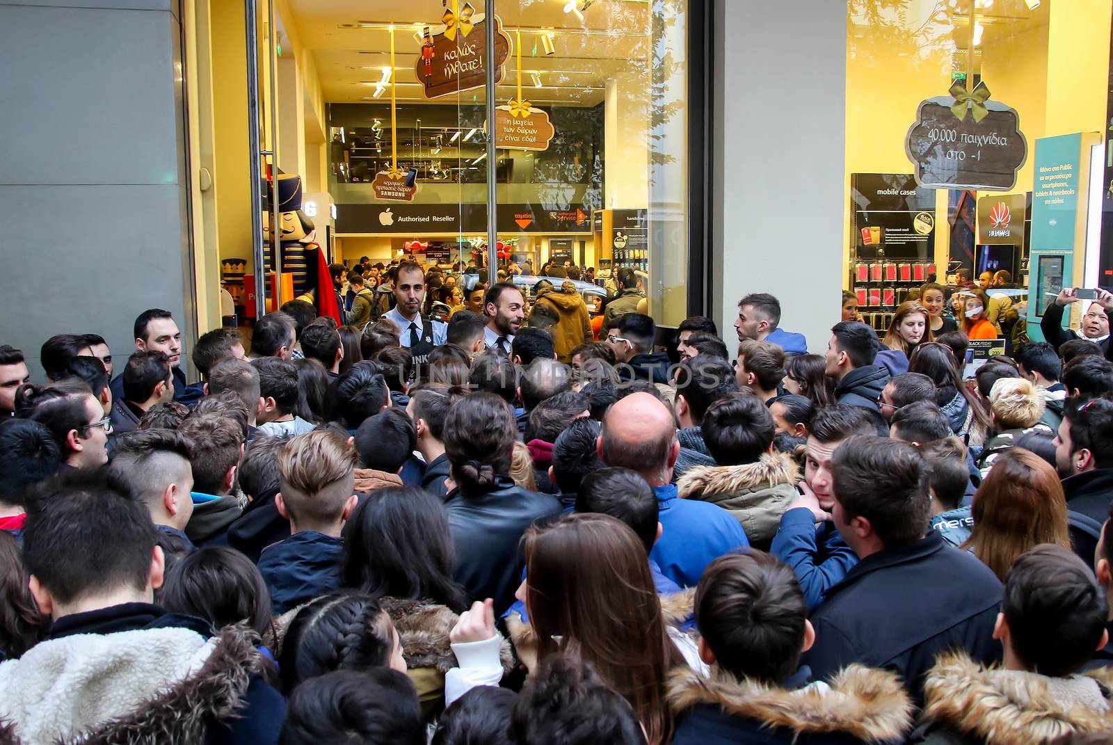 People wait outside a department store during Black Friday shopp by ververidis