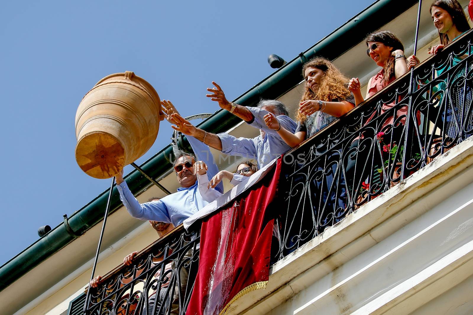 Corfians throw clay pots from windows and balconies on Holy Satu by ververidis