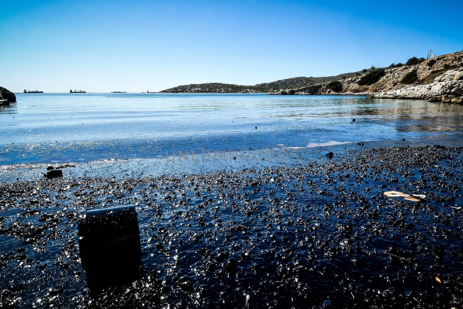 Oil, leaked from a sinked ship, come ashore in Salamina Island n by ververidis