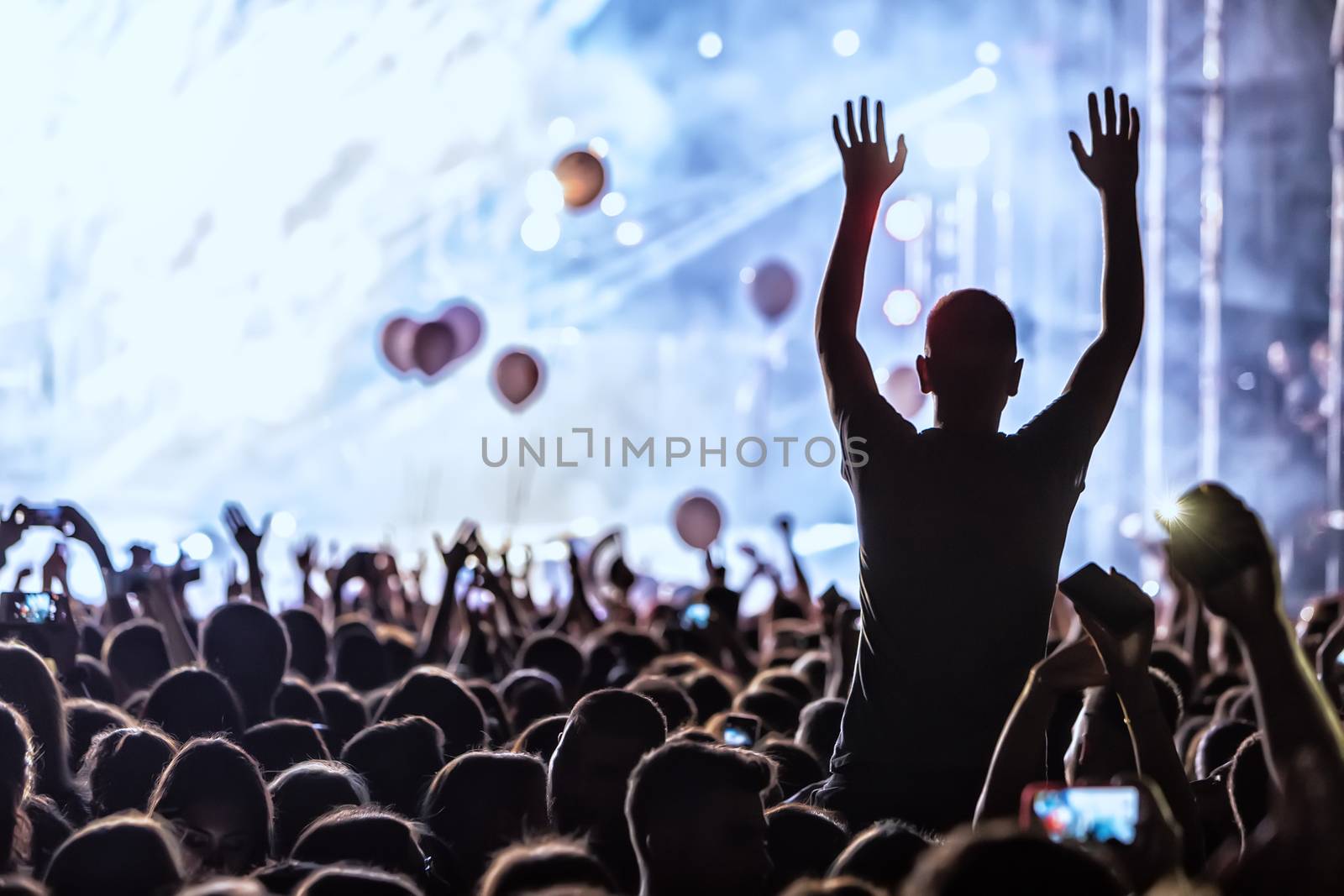 Hand with a smartphone records live music festival, Taking photo of concert stage, live concert, music festival, happy youth, luxury party, landscape exterior