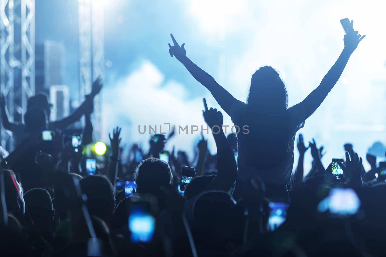 Hand with a smartphone records live music festival, Taking photo of concert stage, live concert, music festival, happy youth, luxury party, landscape exterior