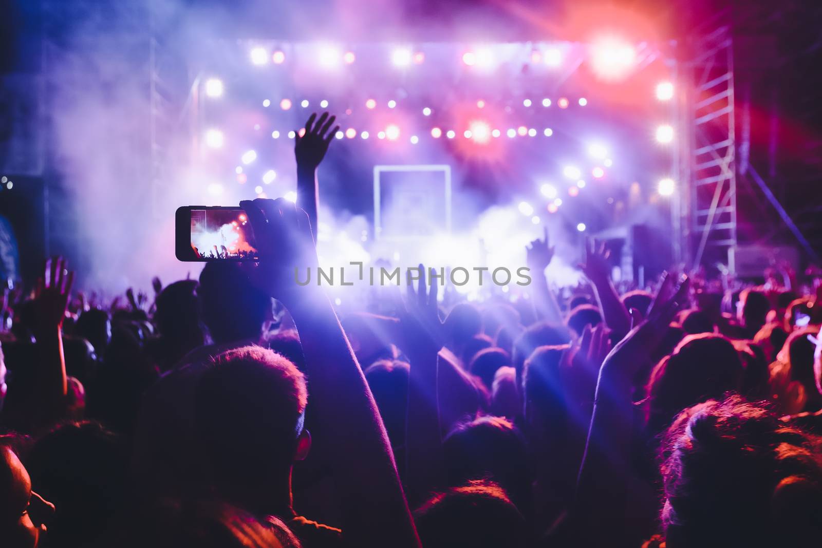 People taking photographs with smart phone during a public music by ververidis