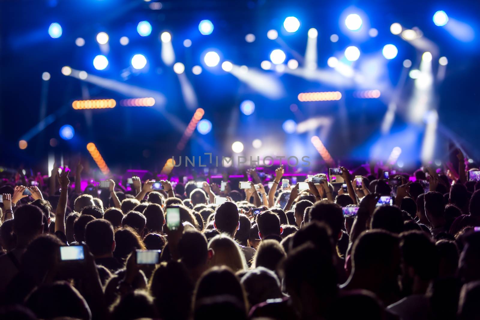 Thessaloniki, Greece - September 11, 2016: Hand with a smartphone records live music festival, Taking photo of concert stage, live concert, music festival, happy youth, luxury party, landscape exterior.