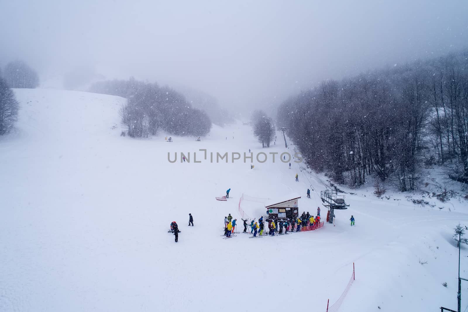 Naousa, Greece - January 13, 2018: Aerial View of skiers at Ski Resort 3-5 pigadia during the snowfall in the mountain Vermio.It is a modern ski resort with ski slopes with every degree of difficulty