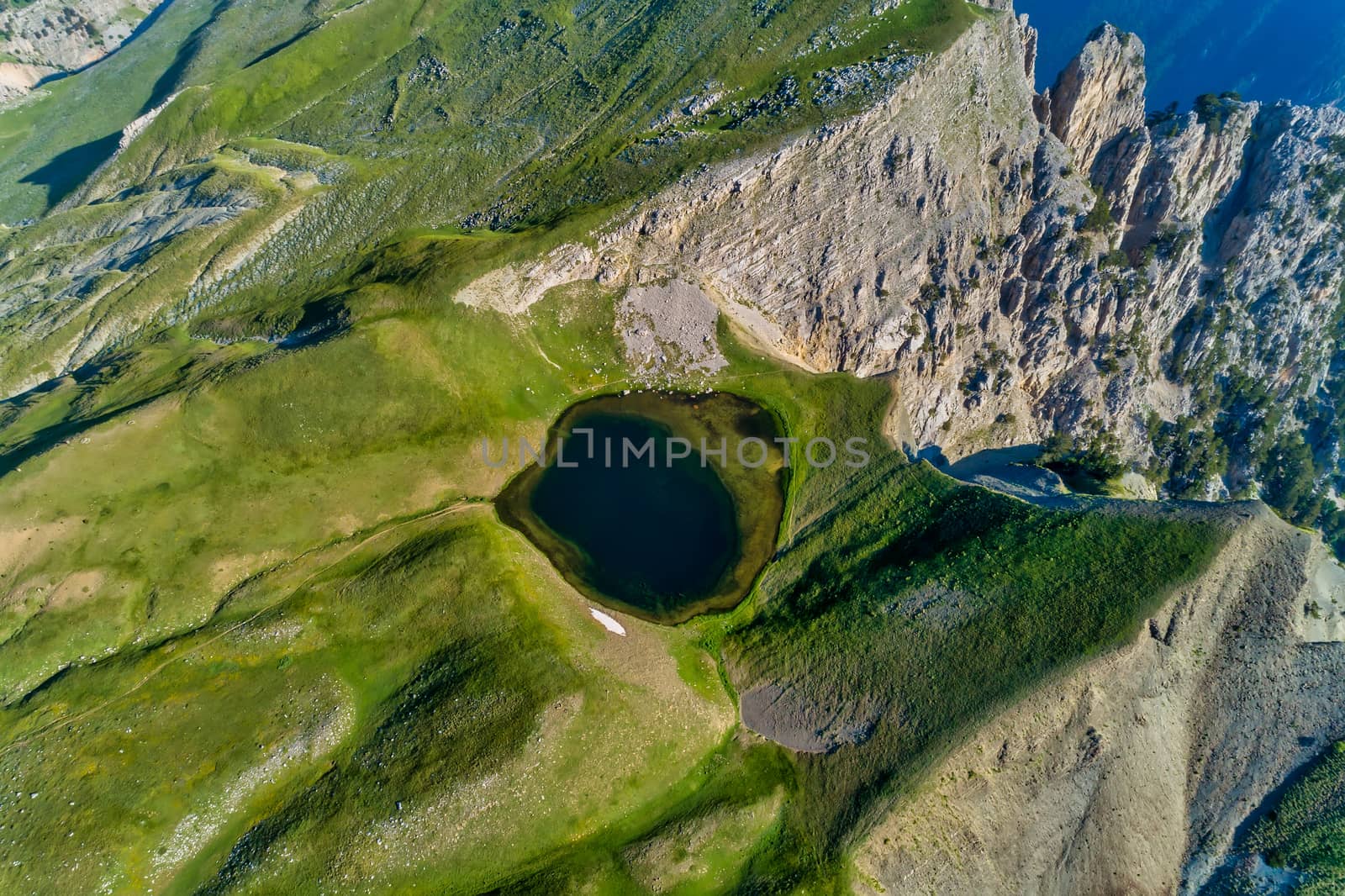 Drakolimni of Tymfi. The lake resides at an altitude of 2050m above sea, in Vikos National Park in Greece. At 5 hours walking distance from the village of Papingo, is a popular trekking destination 