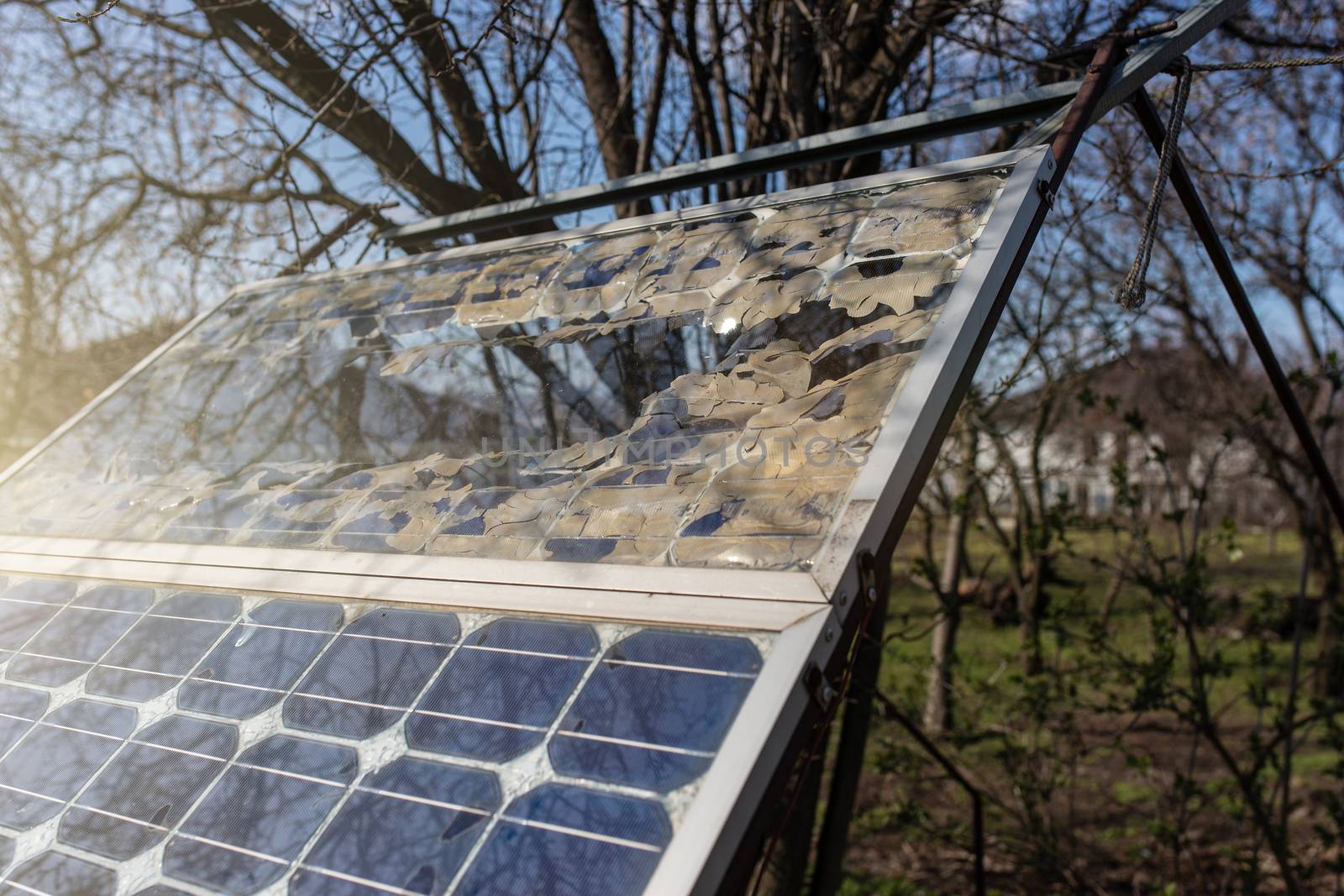 Destroyed old small solar panel photovoltaic electric system for home in the village. Alternative energy concept.